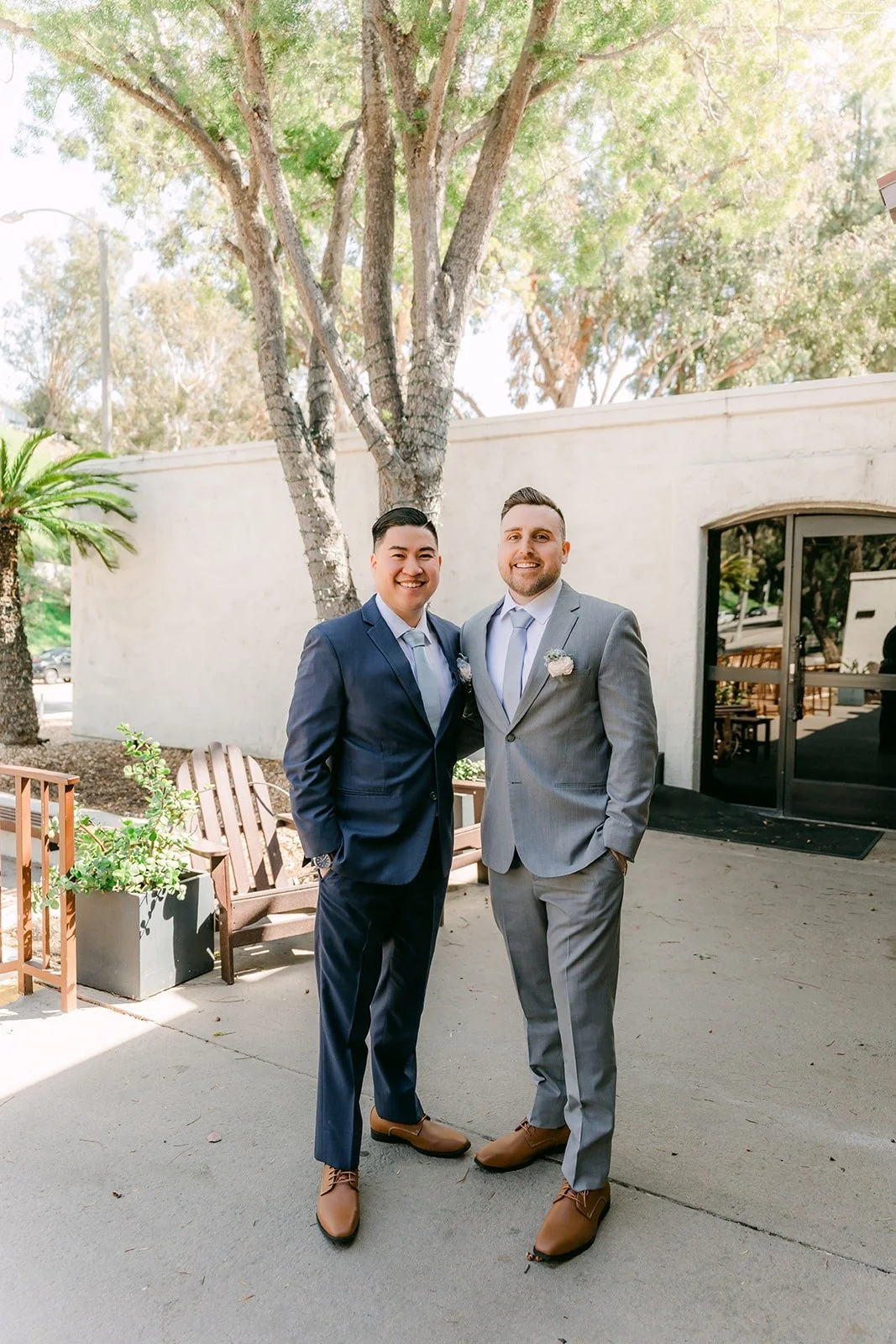 Jordan and a groomsman in gray standing outside the clubhouse