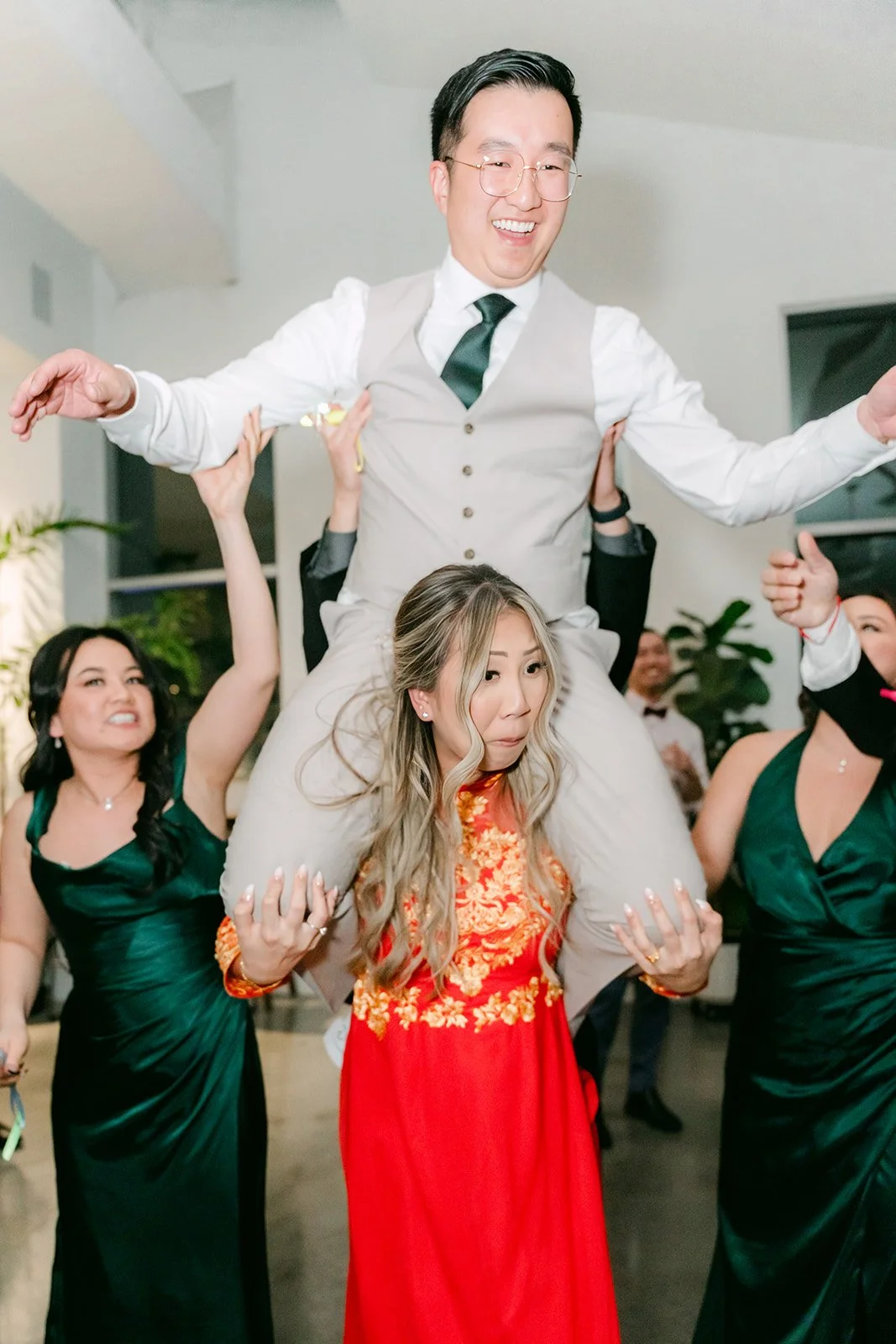 Ricky lifted up on the dance floor as bridesmaids cheer