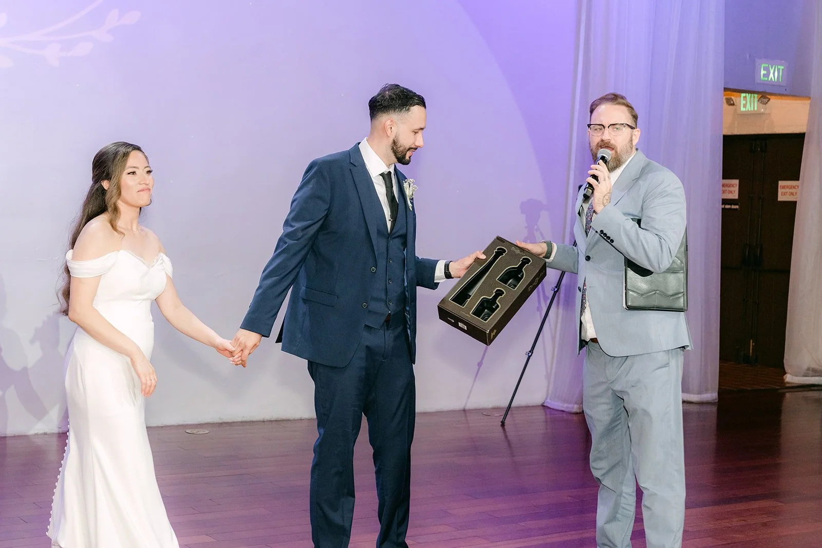 A guest with a microphone joining Mariana and Danny on the dance floor, photographed by One and Only Production
