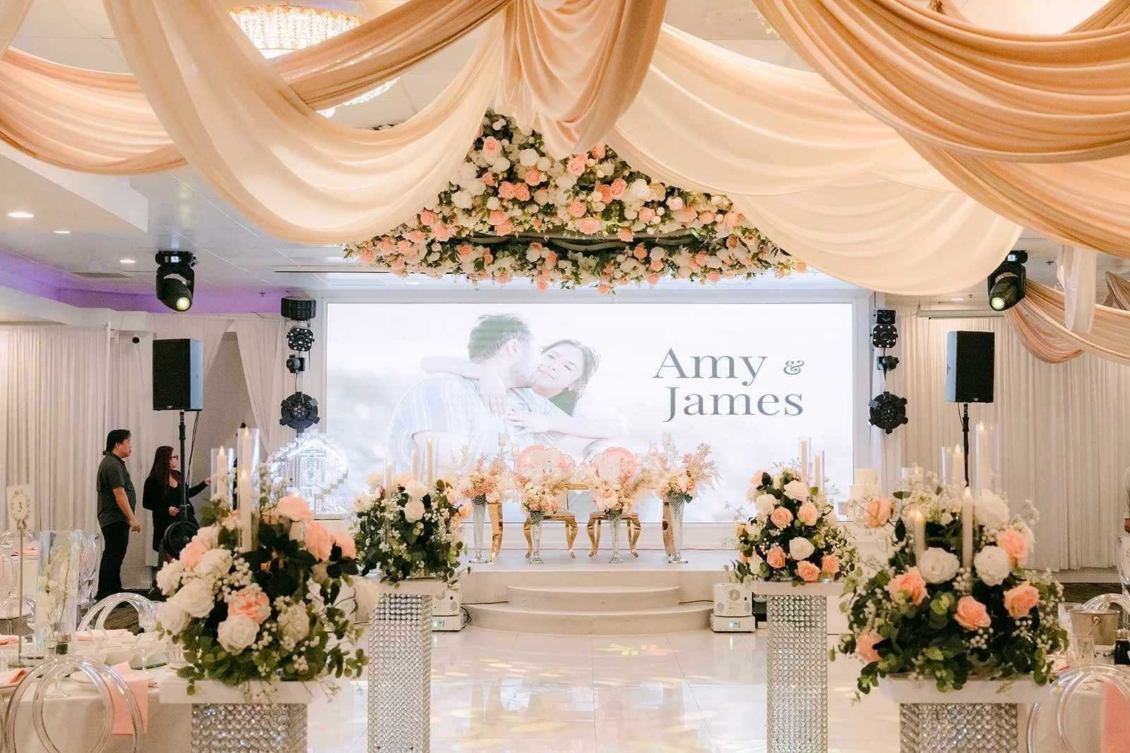 The reception hall at Diamond Seafood Palace with draped ceiling and Amy and James's name on the screen