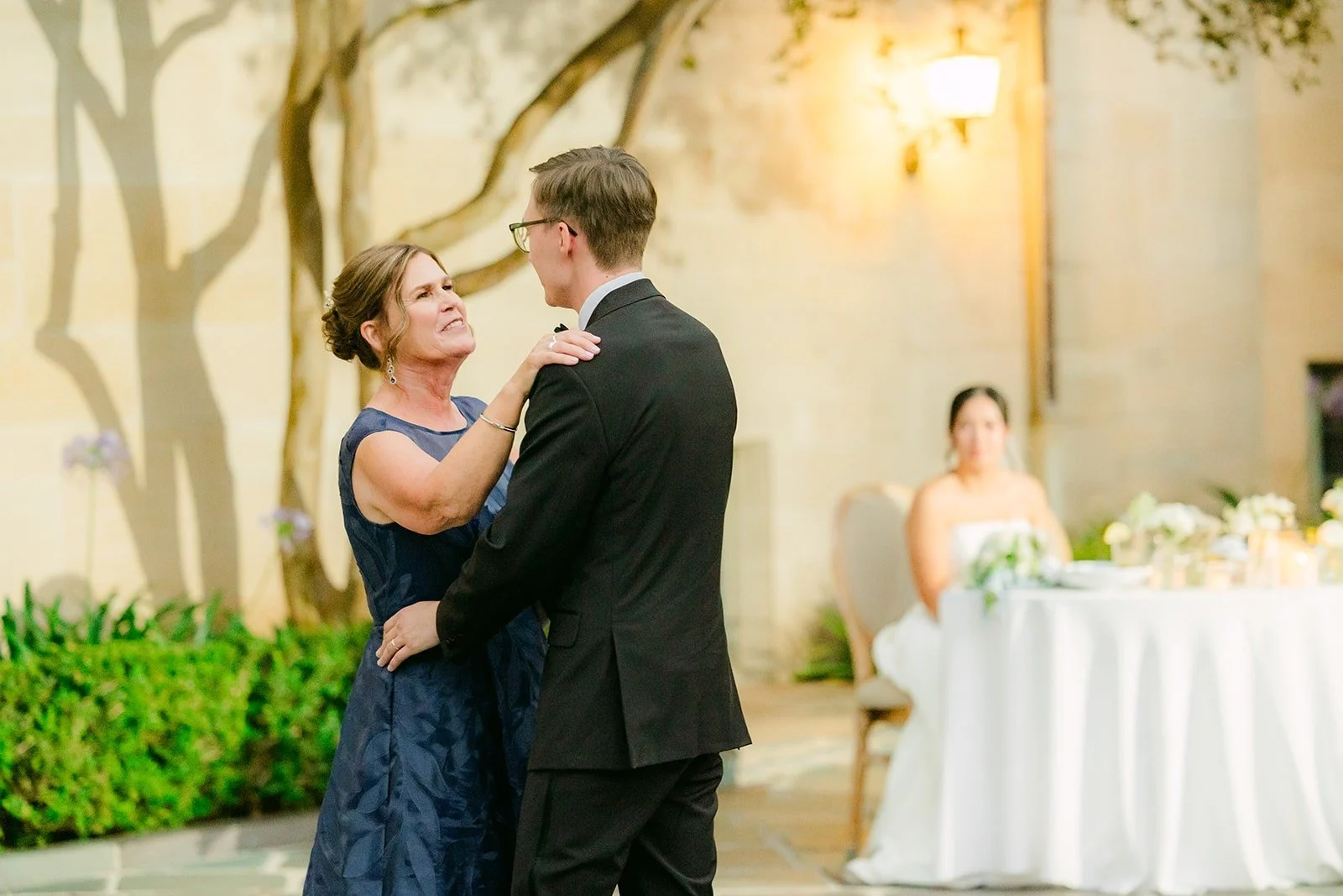 Nik and his mom finishing their dance near the sweetheart table