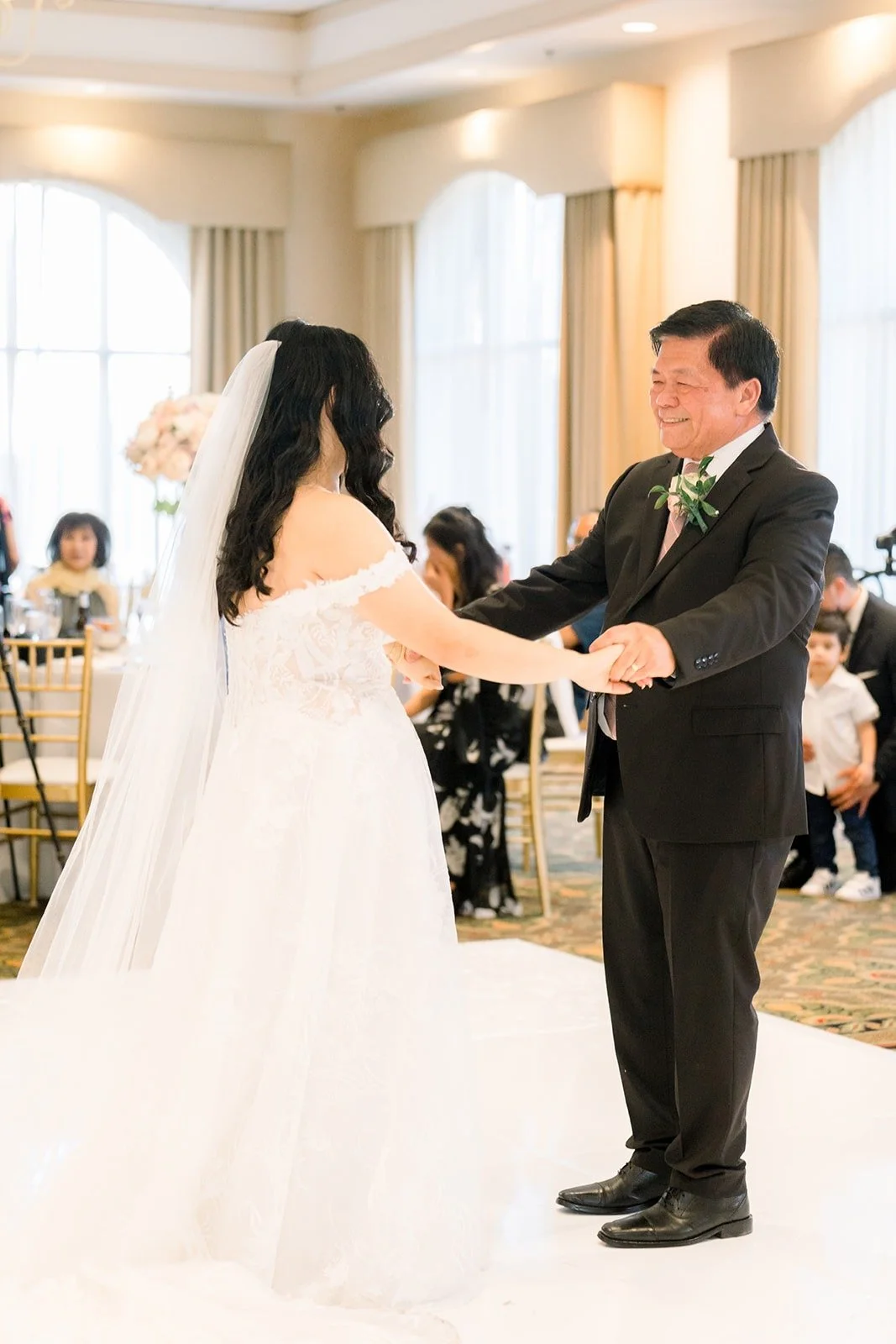 Francesca and a family member sharing a dance as guests look on
