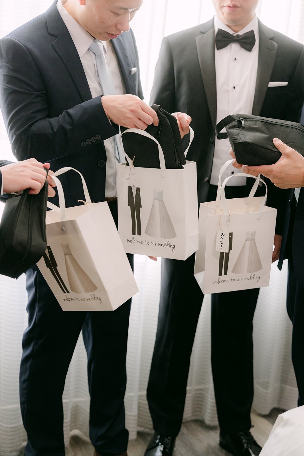 San's groomsmen opening their gift bags.