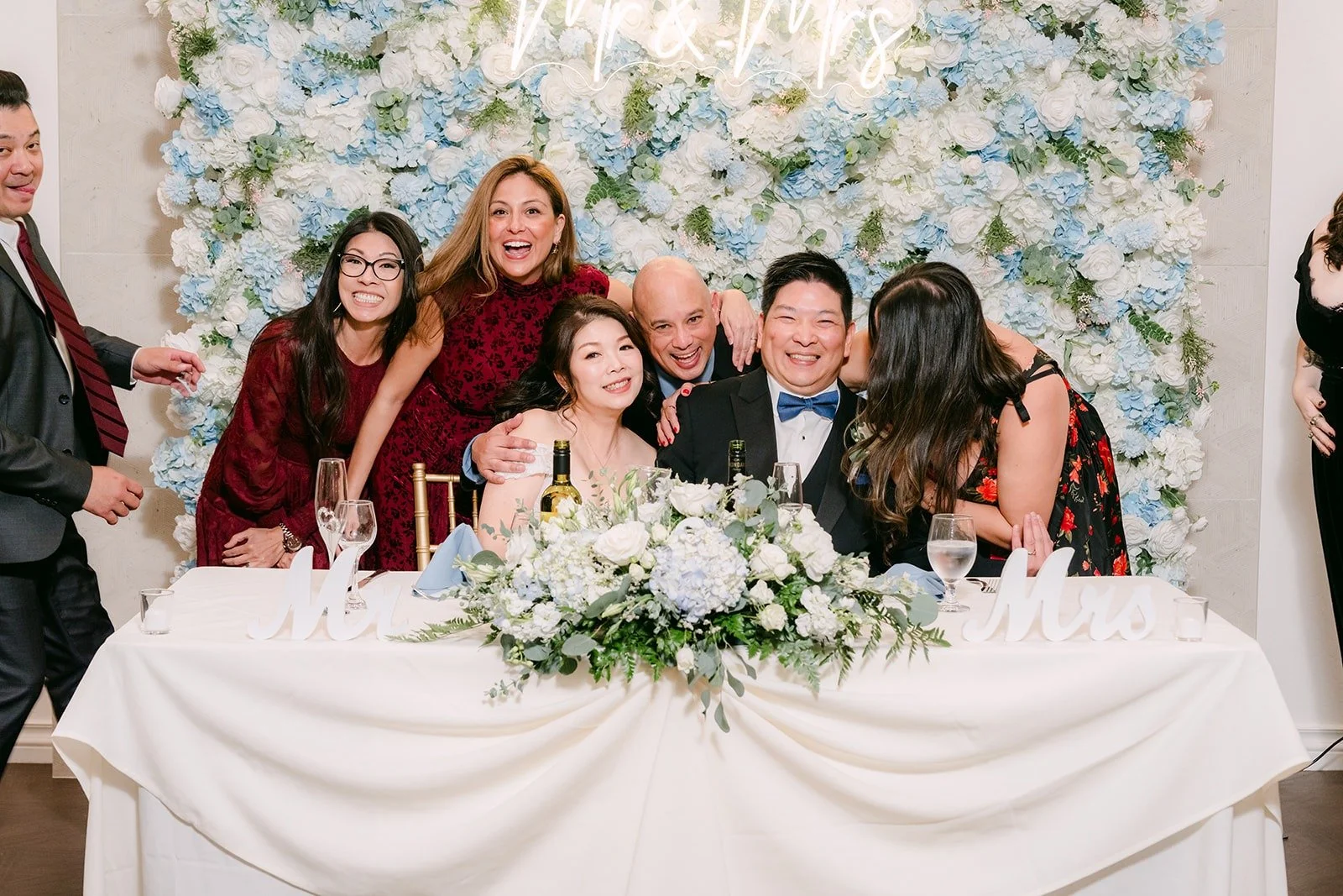 Friends gather around Sochi and Jay at the sweetheart table