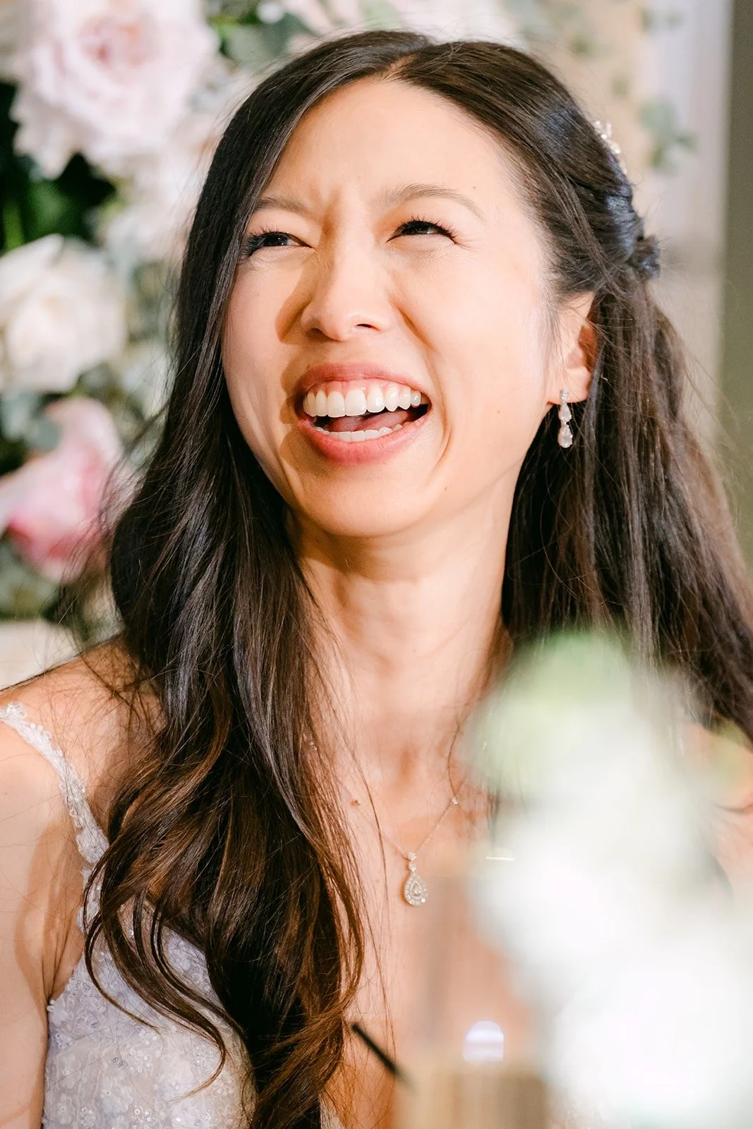 Kristine laughing during a speech