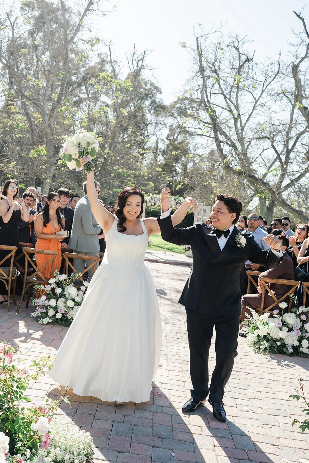 Newlyweds celebrating as they walk back up the aisle