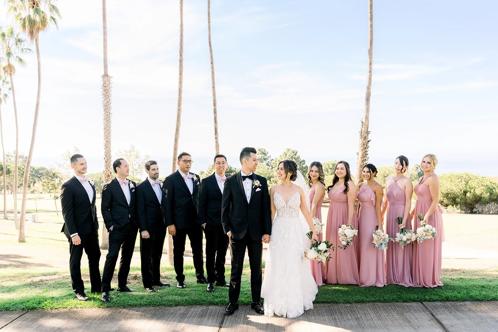 Wide view of the wedding party on the golf course lawn