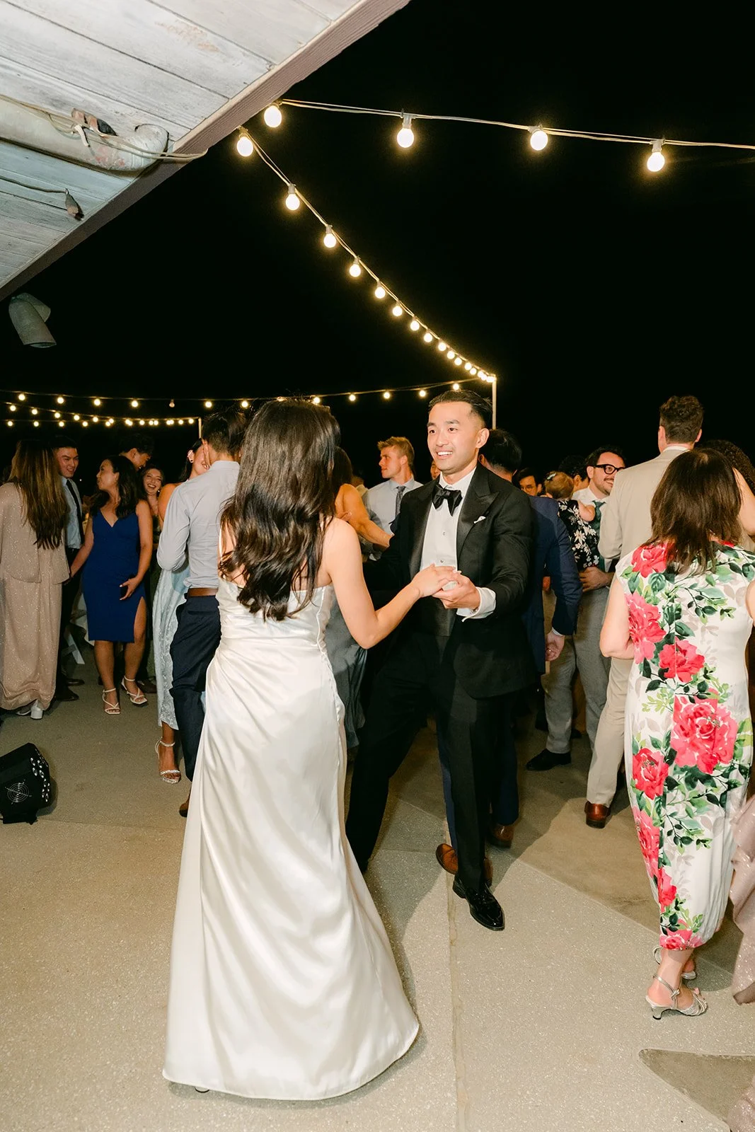 Kim and Vincent dancing as guests gather around