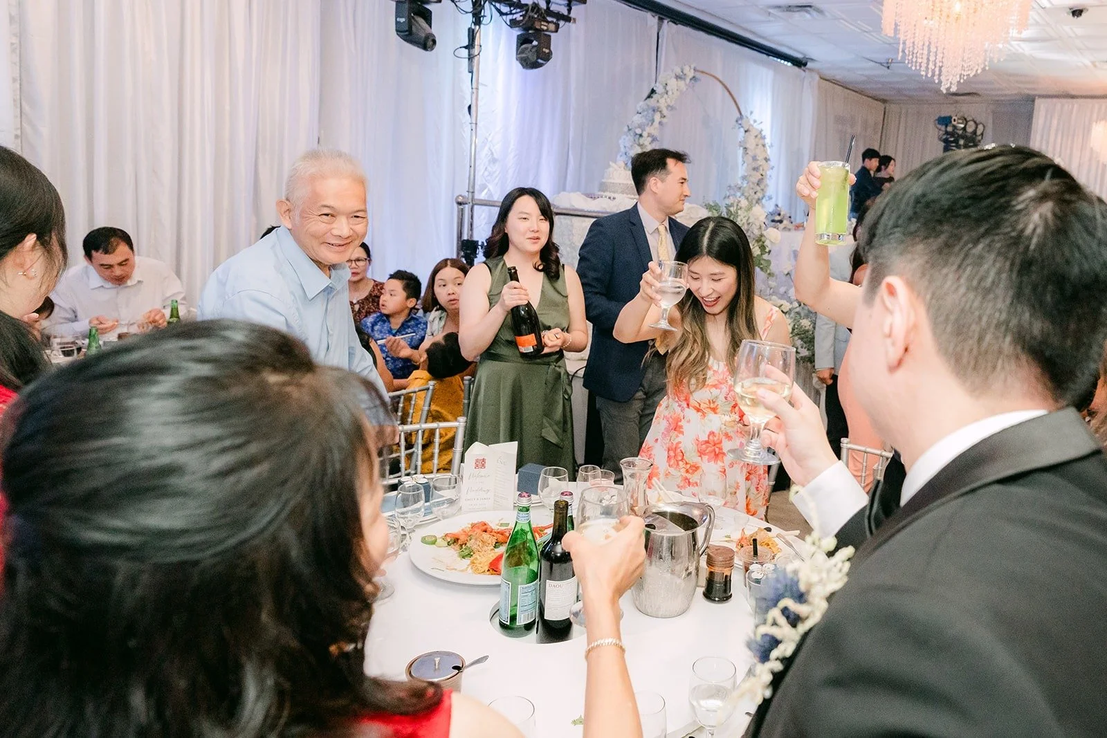 Guests standing to toast the couple
