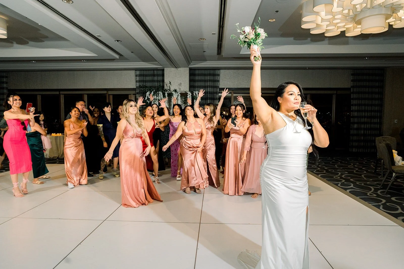 Betsy tosses her bouquet to the waiting guests