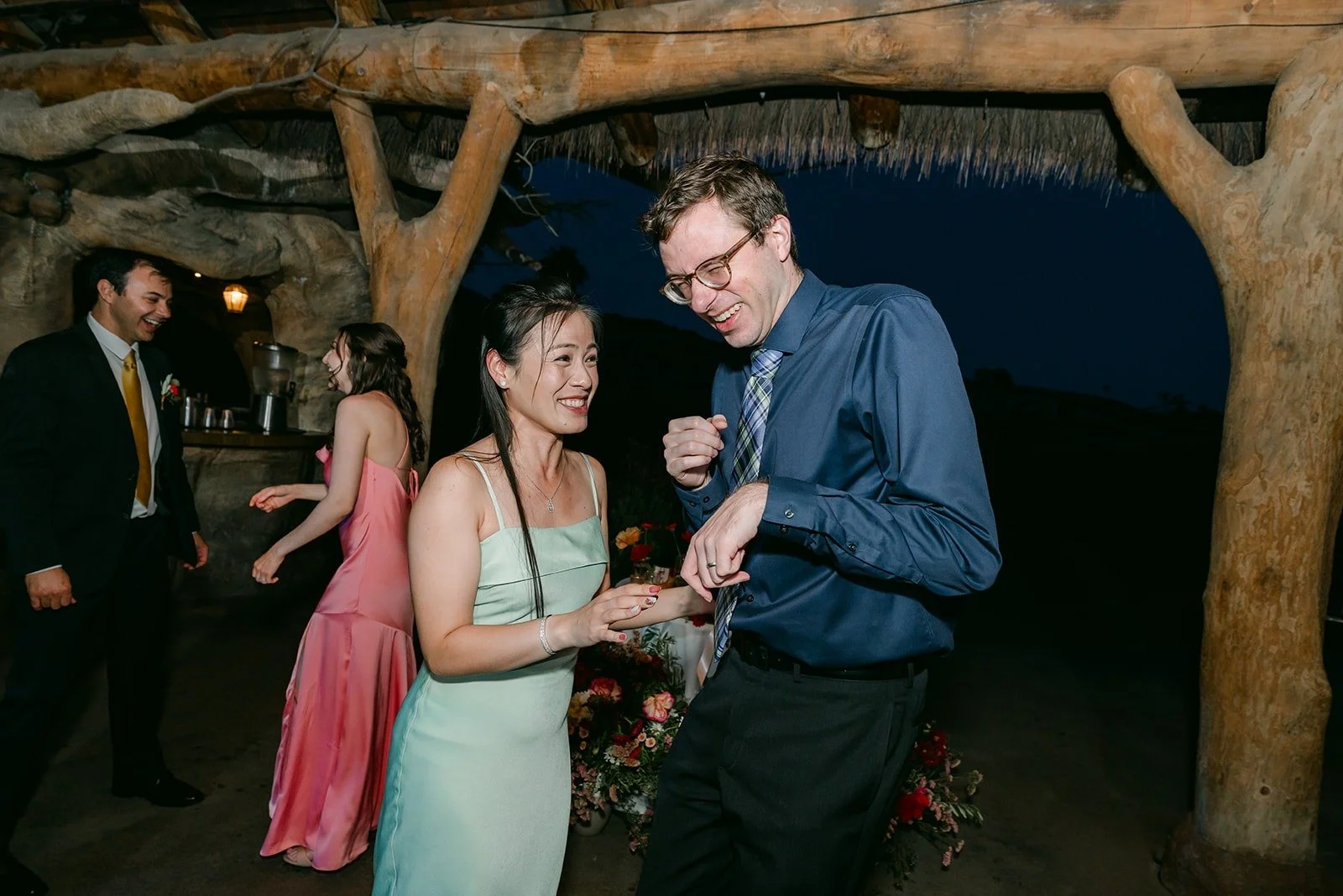Joanne and Zach dancing with a guest on the dance floor