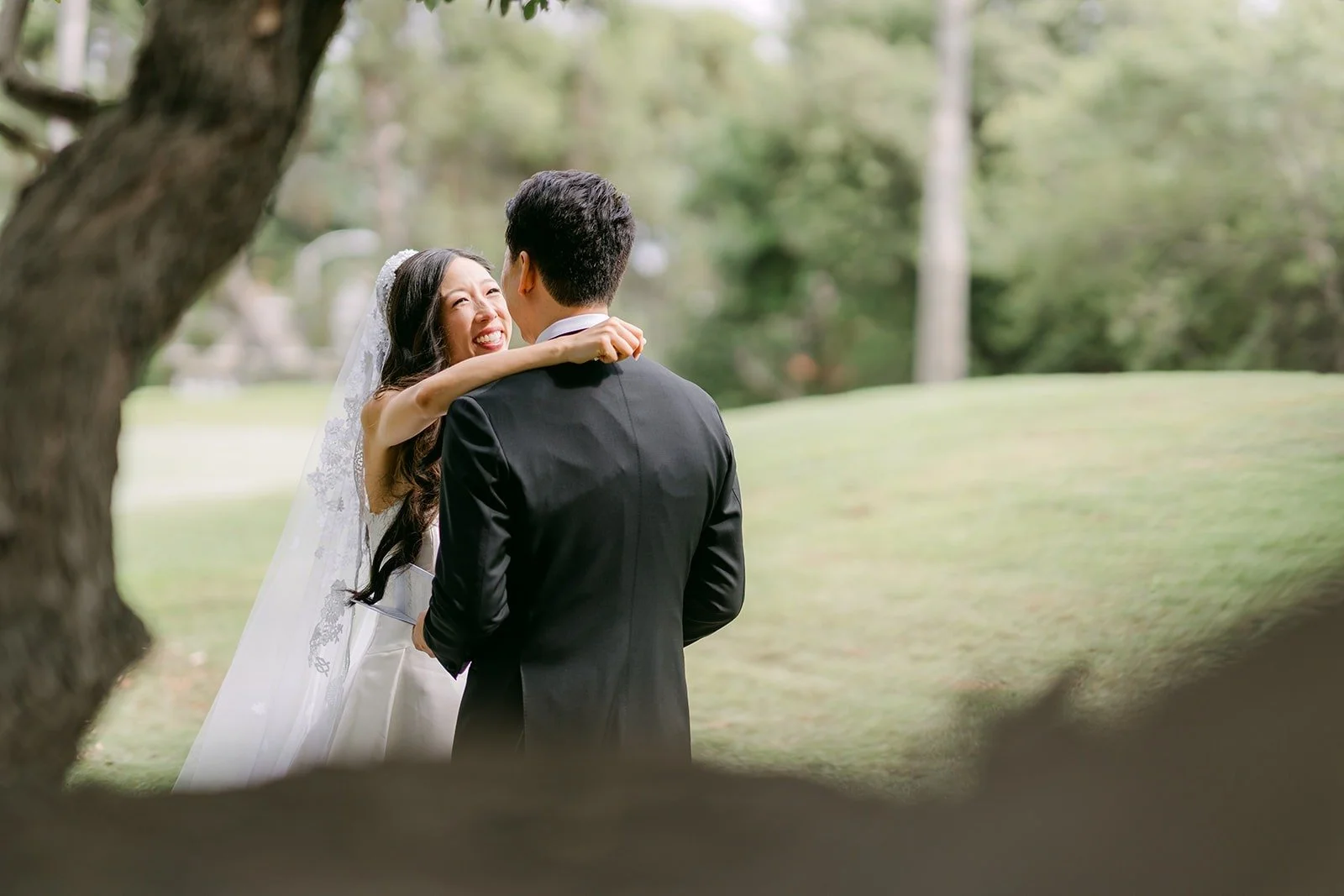 Kristine and William in a quiet hug under the trees