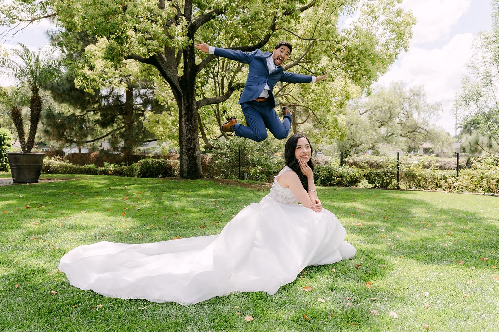 Mark jumping high behind Natalie on the lawn at Rio Hondo Golf Club