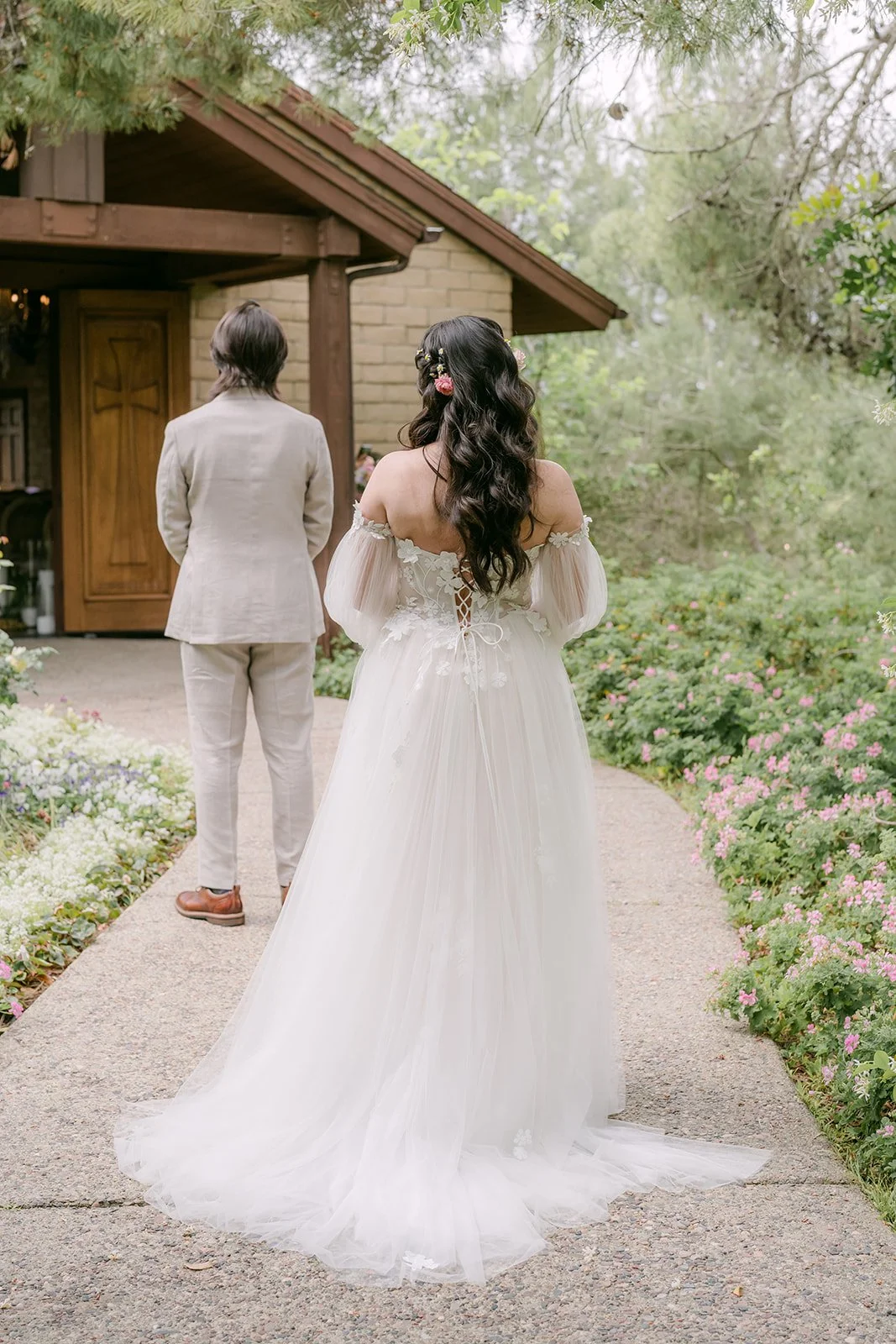 Kat walking up behind Mike on the garden path for their first look at Ethereal Gardens