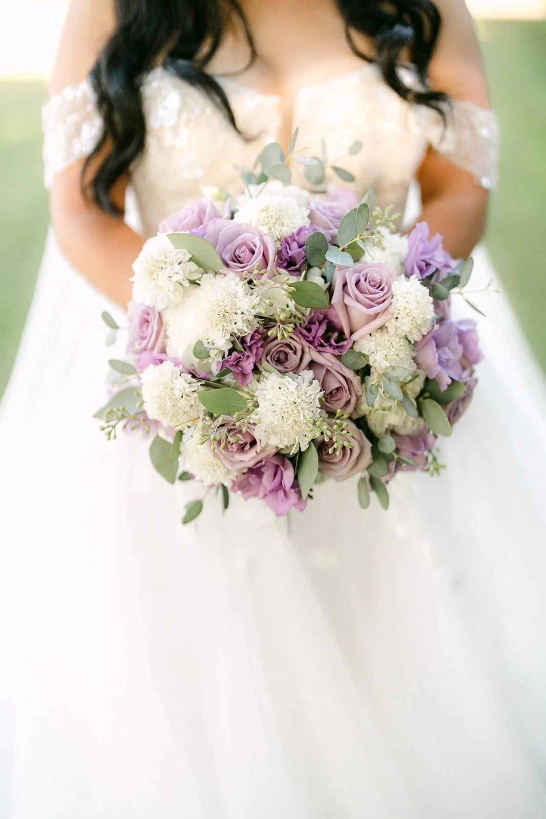 A close look at Jennifer's bouquet of lavender roses and white blooms
