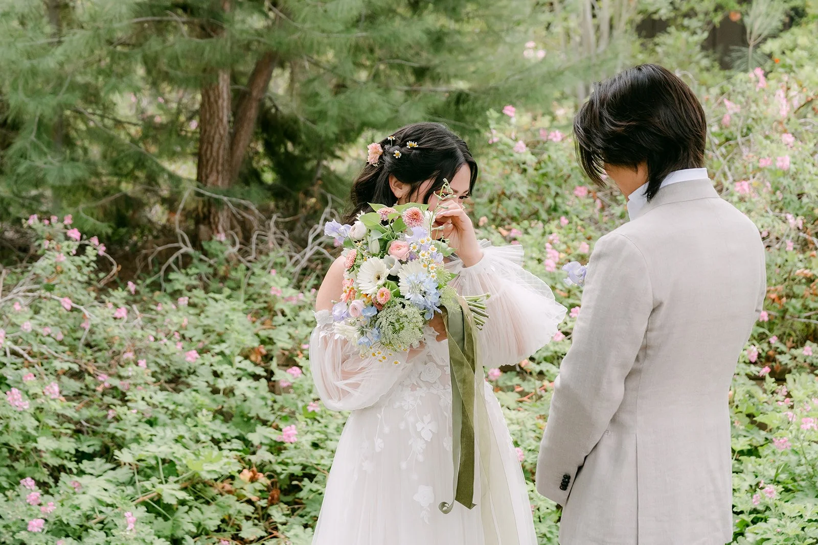 Kat wiping away happy tears with her bouquet in hand