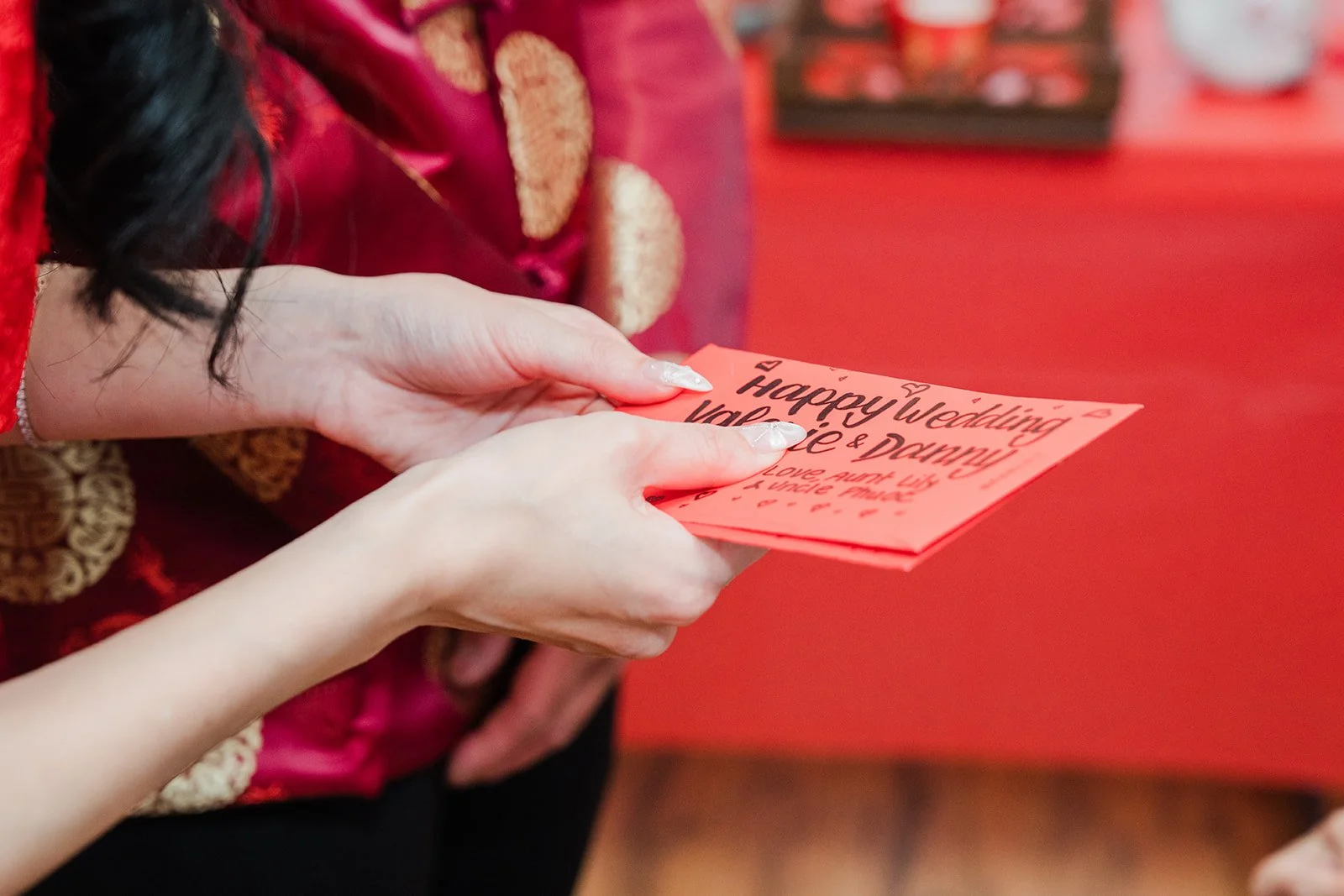A red envelope passed to Valerie.