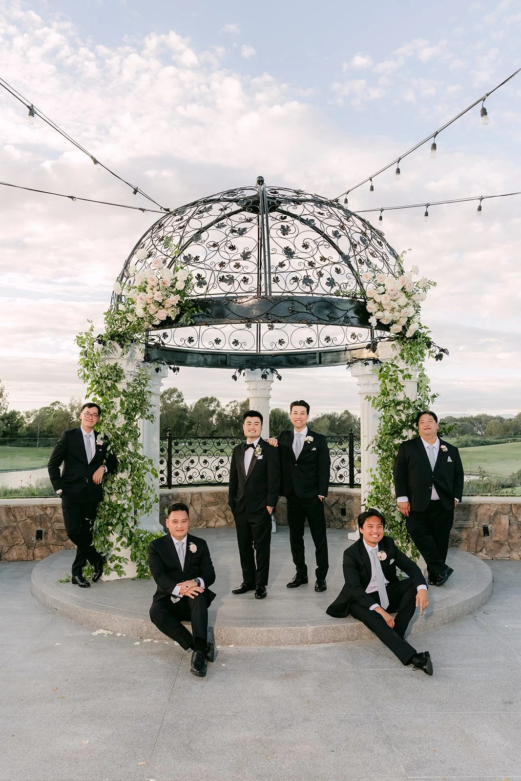 Kenny and his groomsmen goofing around at the gazebo