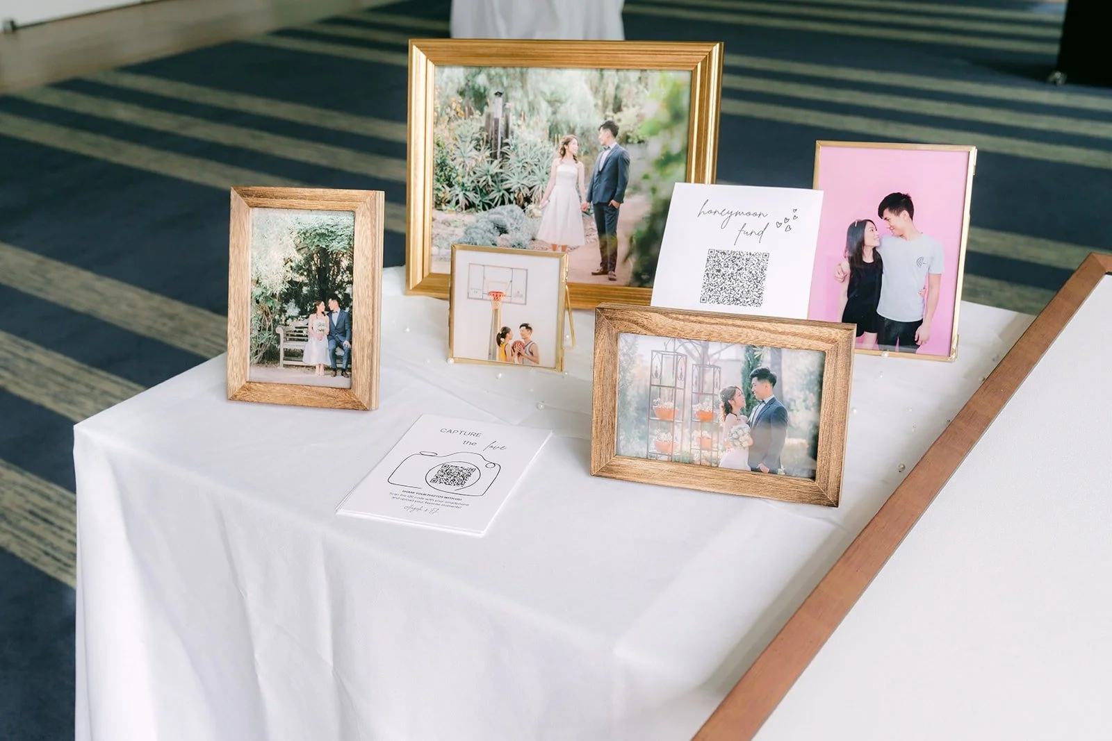 Framed engagement photos displayed on the welcome table