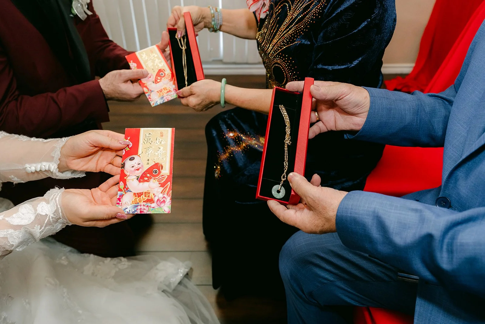 Close-up of red envelopes and a gold jewelry gift.