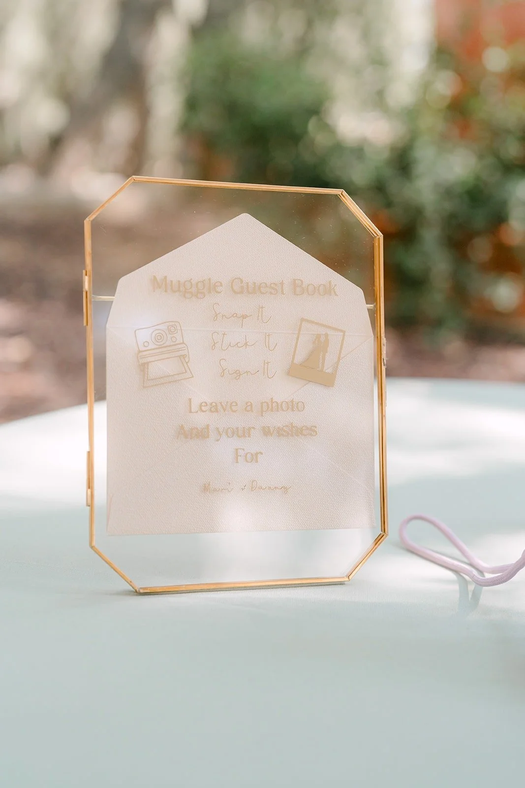 A gold framed acrylic sign on the ceremony table