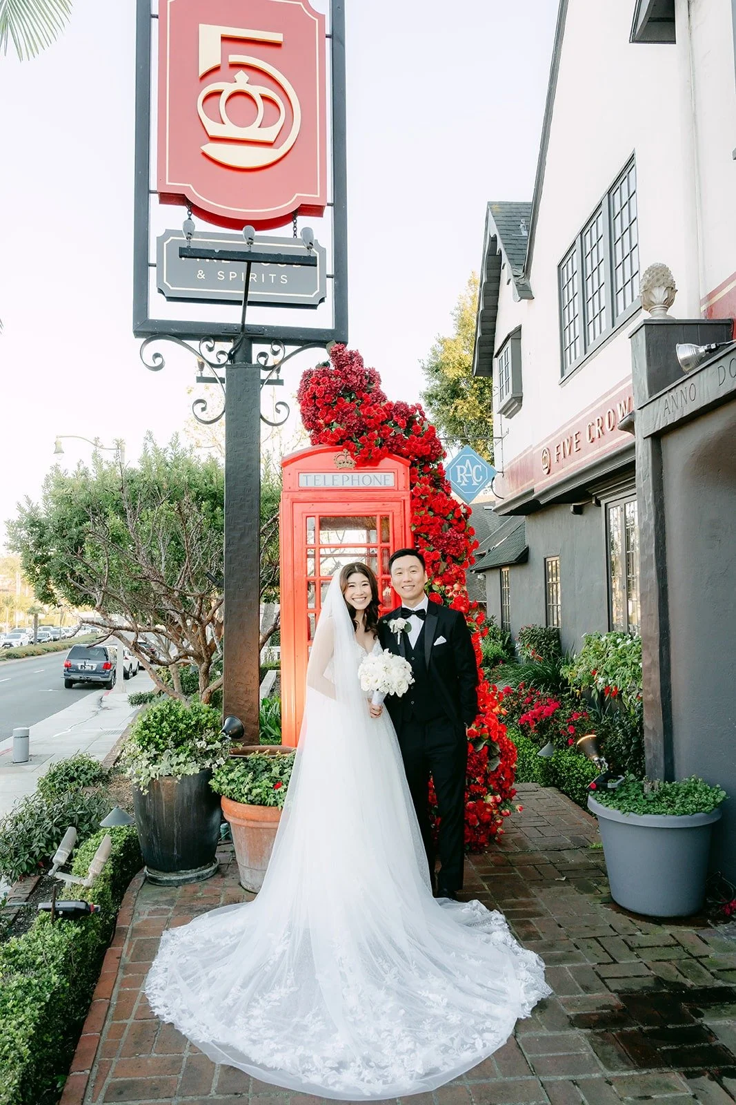 Valerie and Jason on the brick walkway under the Five Crowns sign