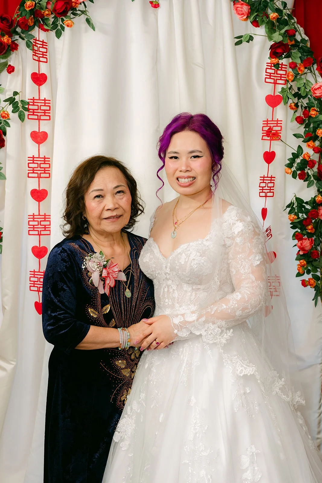 Vanessa with her mom under the arch.