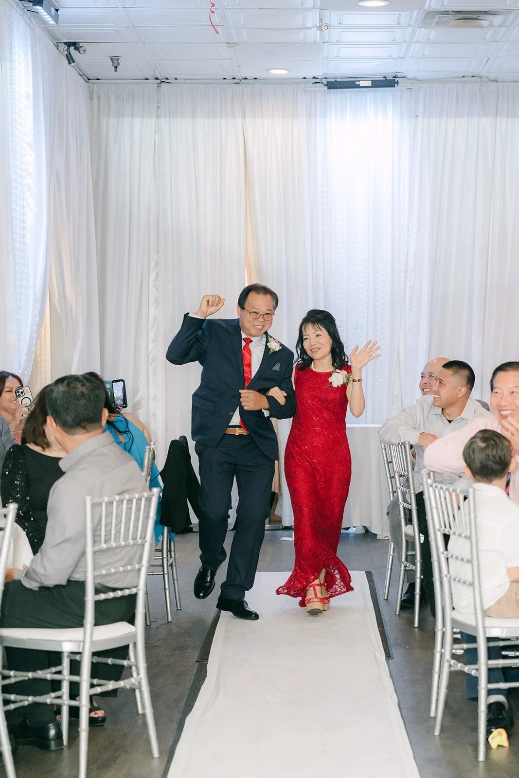 A couple twirling down the aisle during the grand entrance