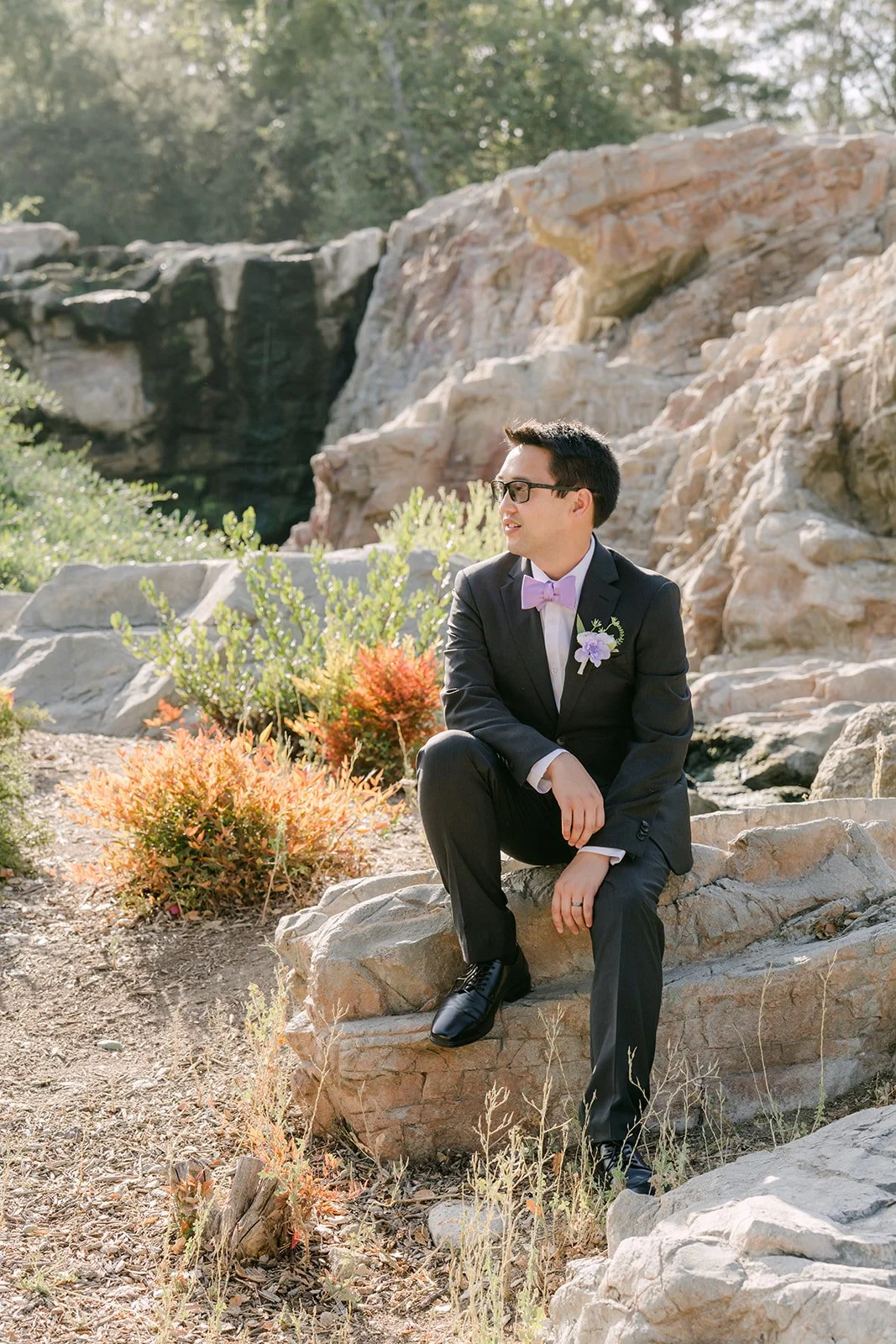 Patrick seated on the rocks