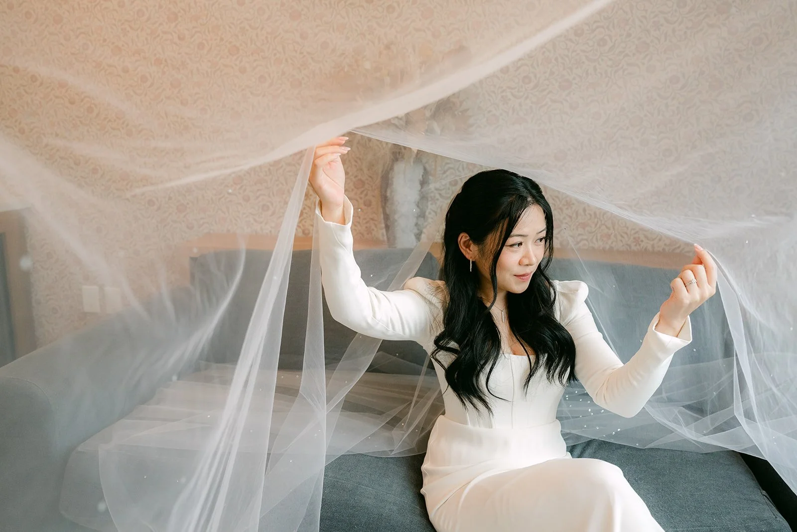 Denise lifting her veil above her like a canopy.