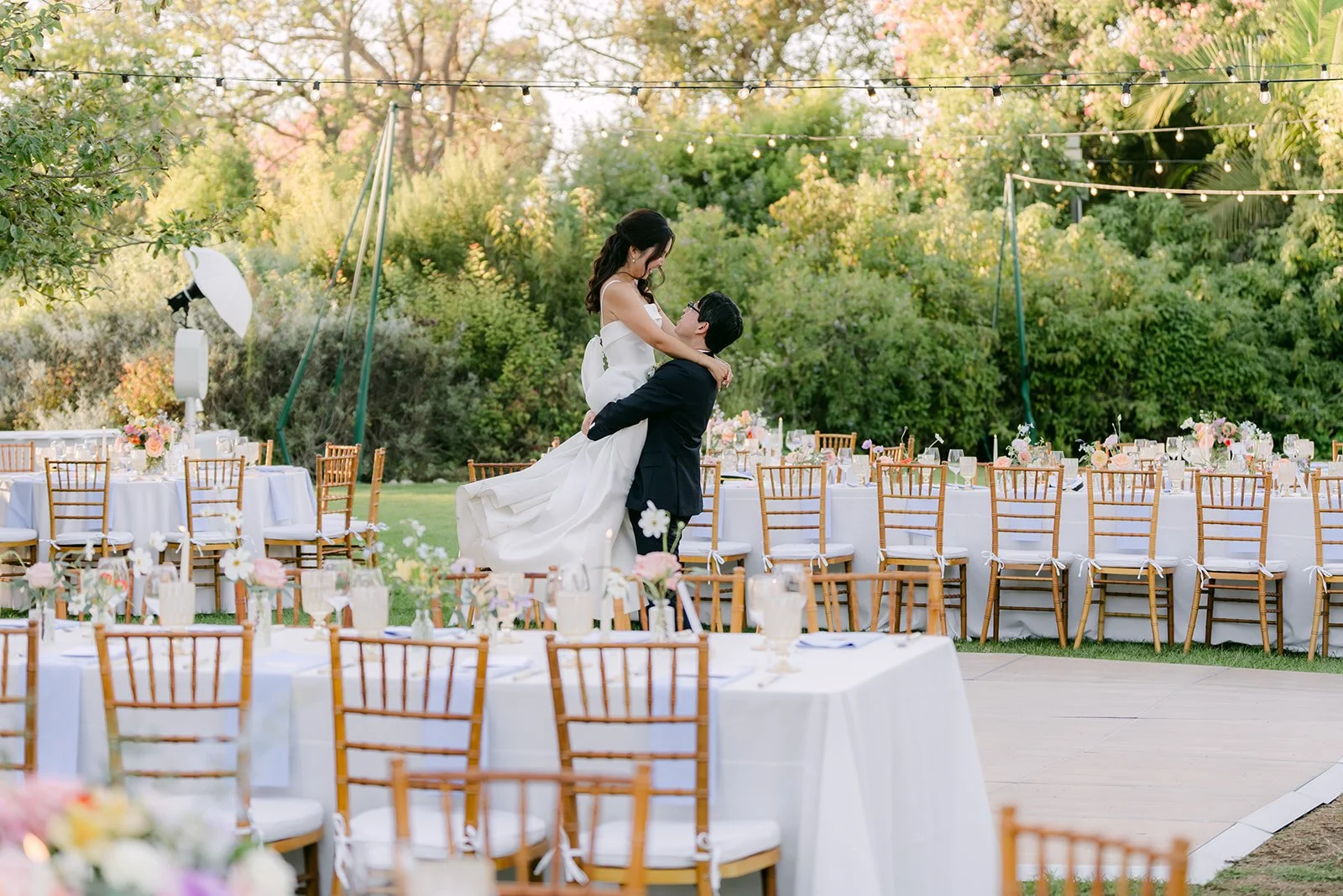 Leroy lifting Saya between the reception tables