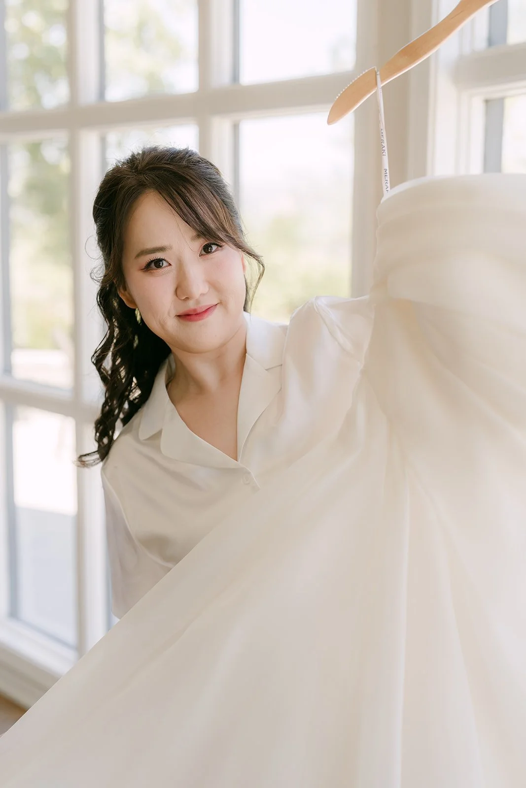 Judy holding her gown in the bridal suite