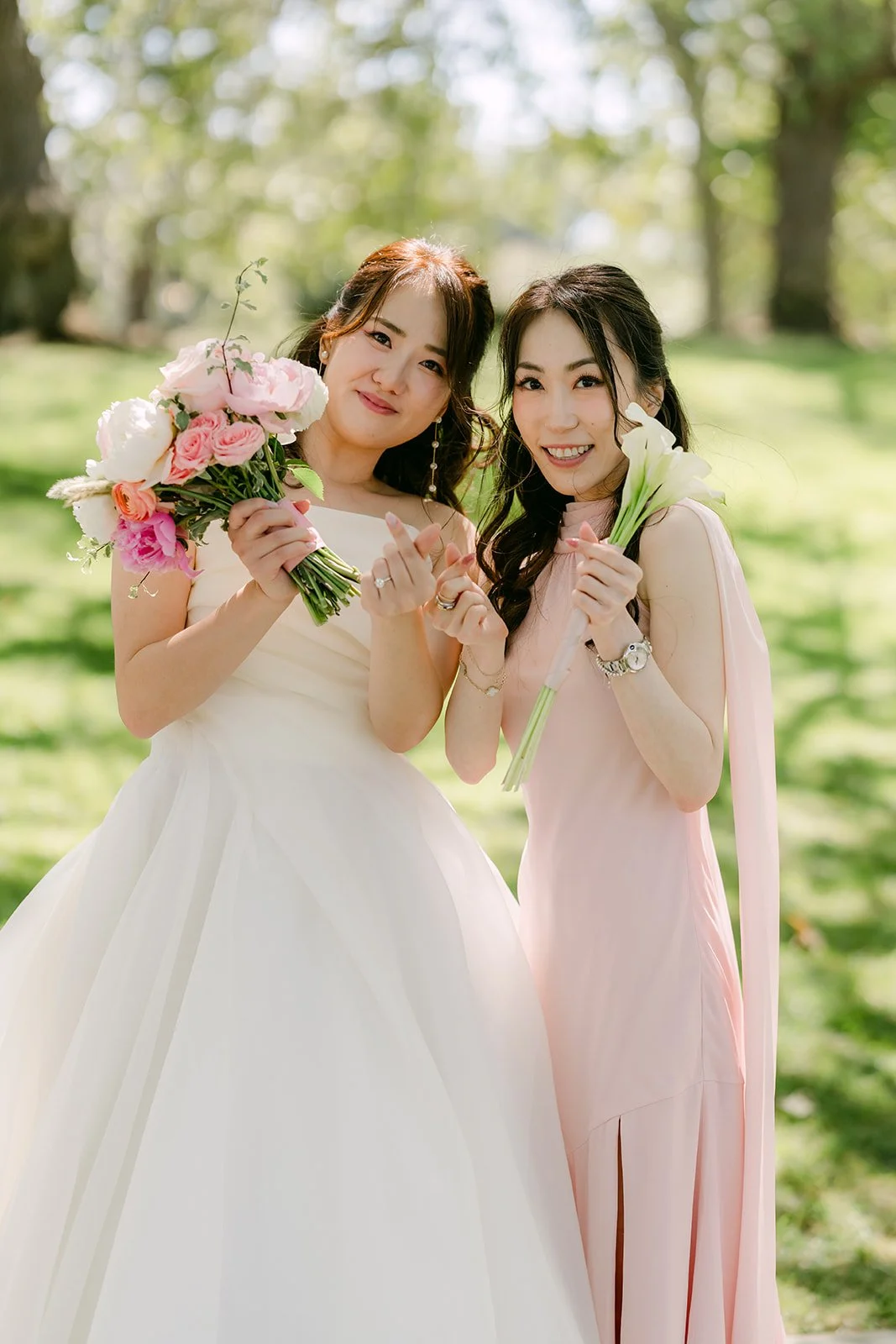 Judy and a bridesmaid holding pink bouquets