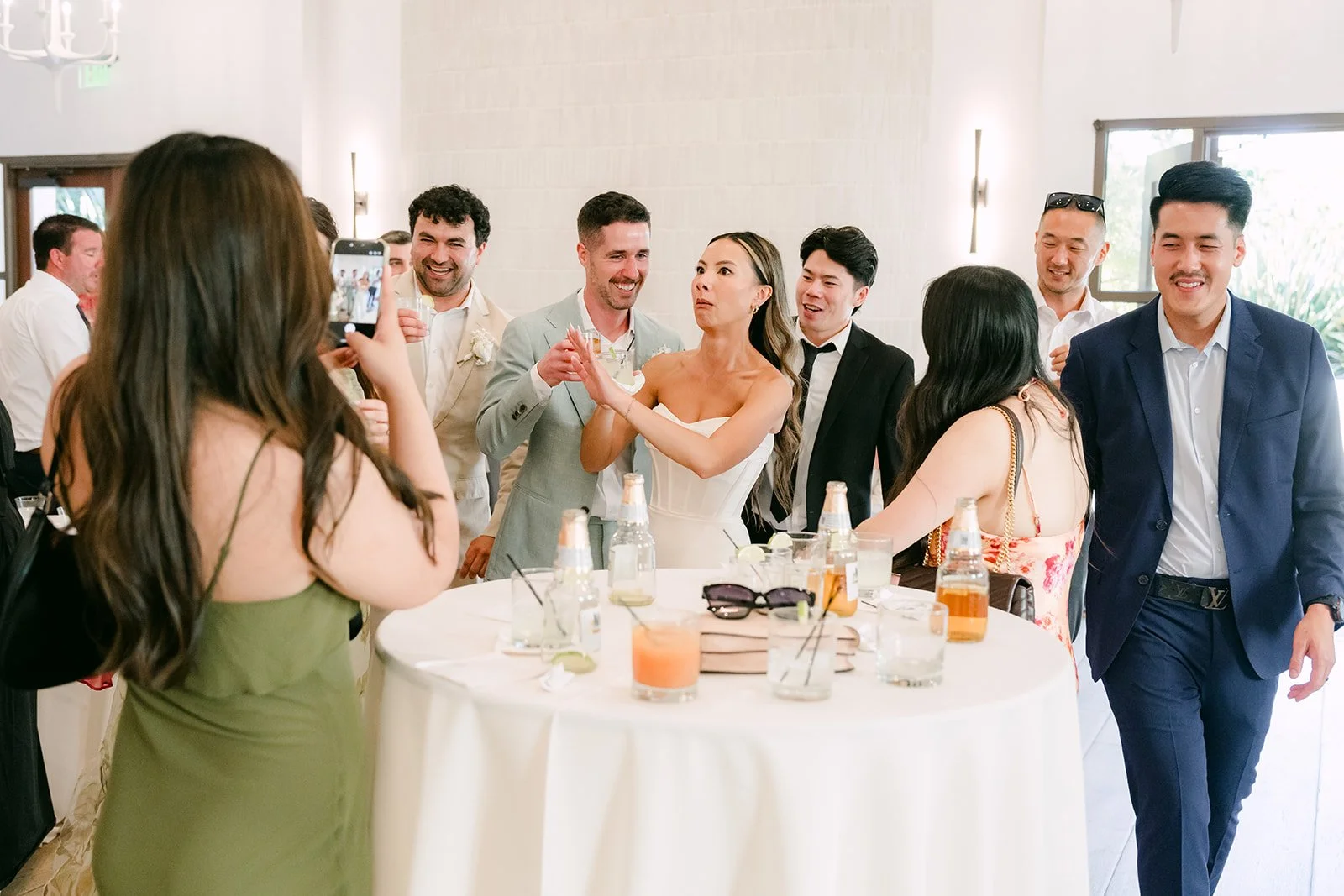 Couple chatting with friends at a cocktail table indoors