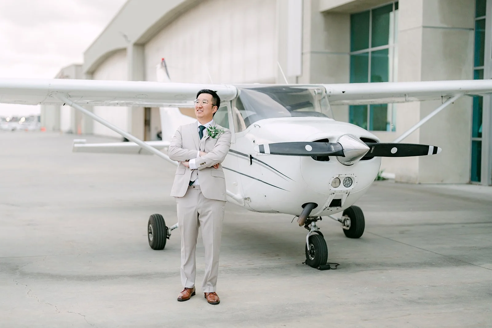 Ricky standing in front of a small white propeller plane