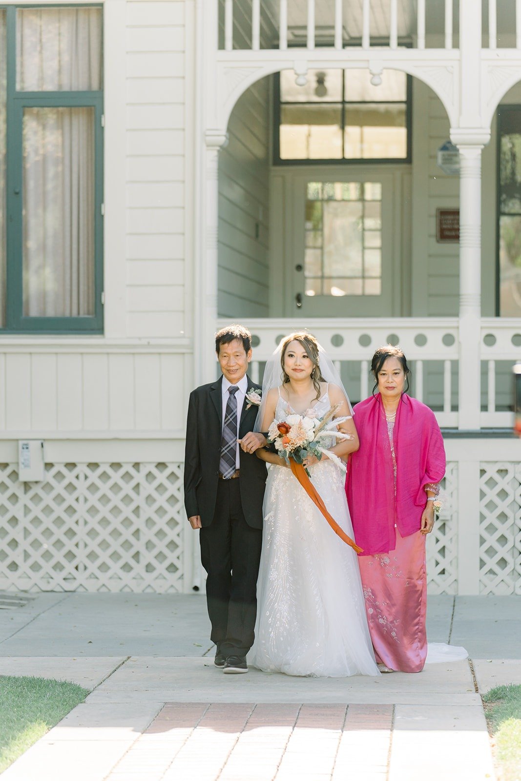 Ariel walked down the aisle by two family members
