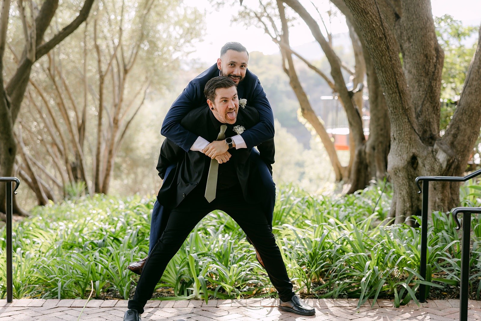Danny's friend jumping on his back for a playful photo, photographed by One and Only Production