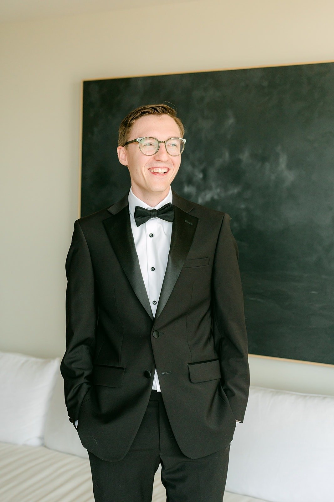 Nik smiling in his tuxedo and bow tie