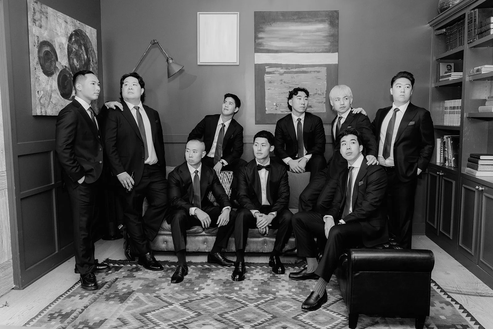 Black and white portrait of Richard and his groomsmen in the library suite