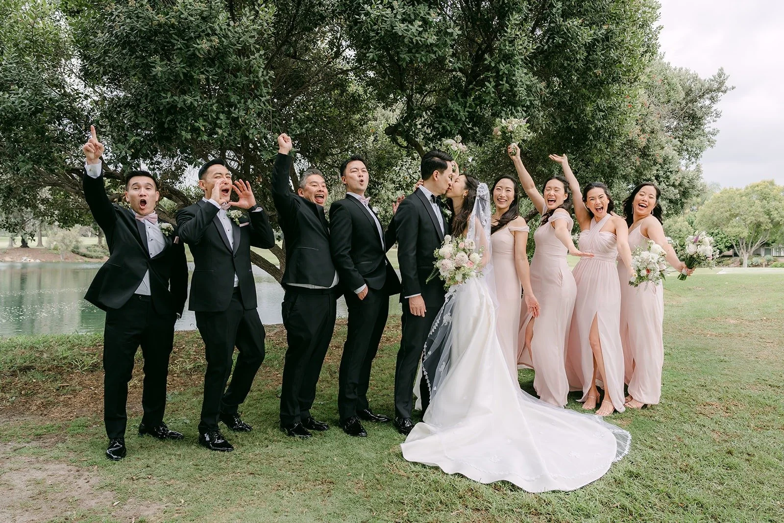 The wedding party lined up on the green at Los Coyotes Country Club