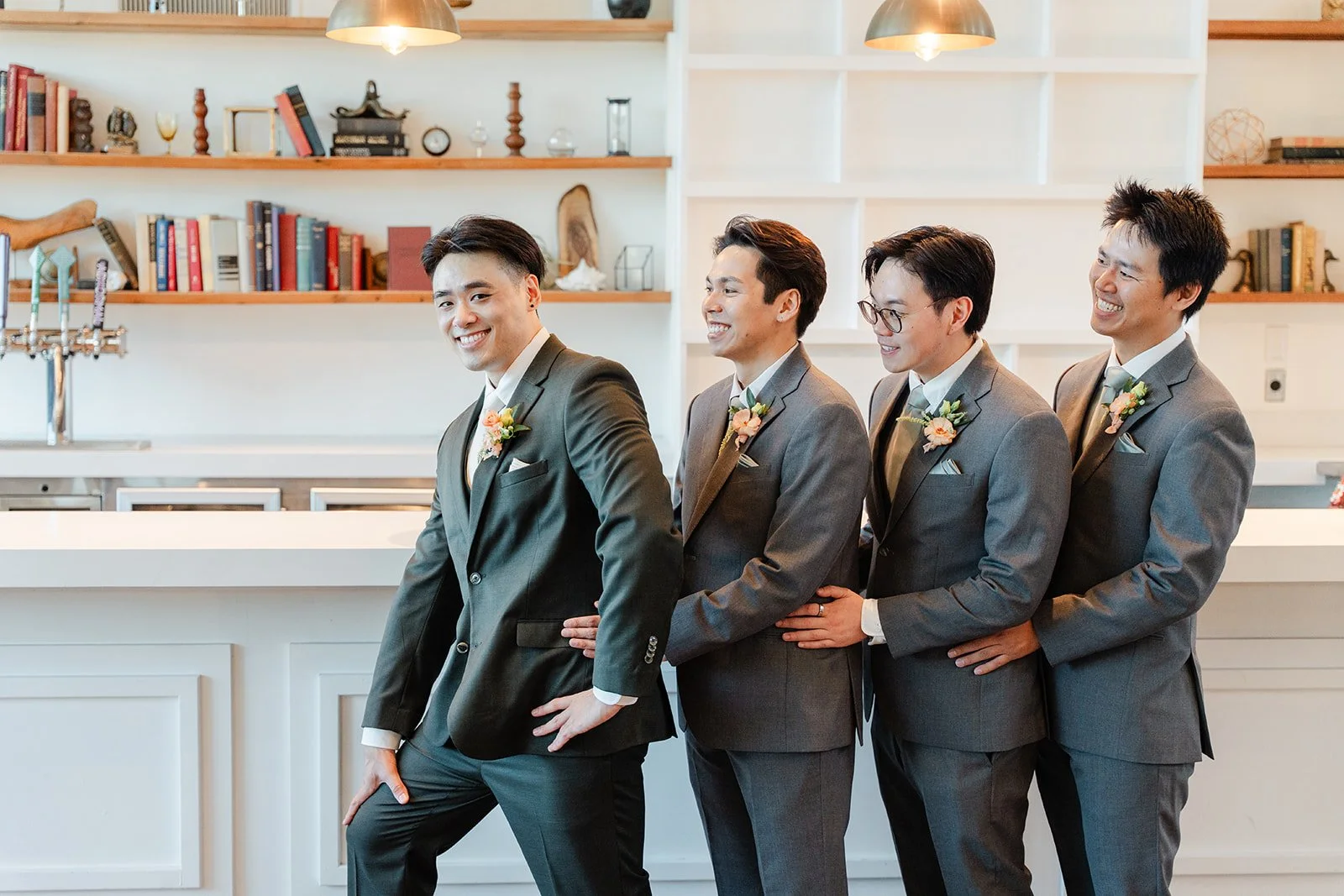 Groomsmen lined up beside Alex