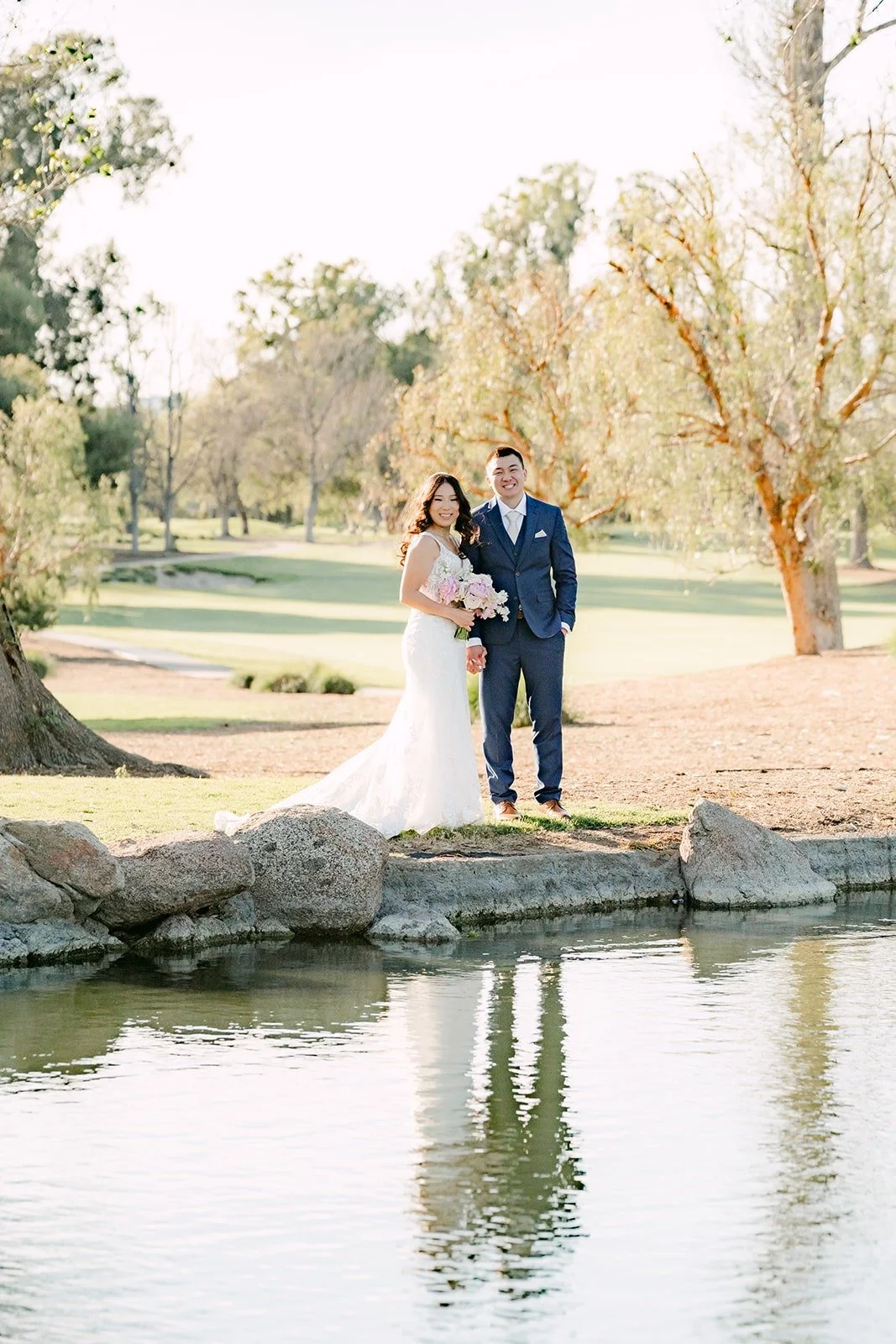 Kelli and Alex reflected in the pond at Los Robles Greens, photographed by One and Only Production