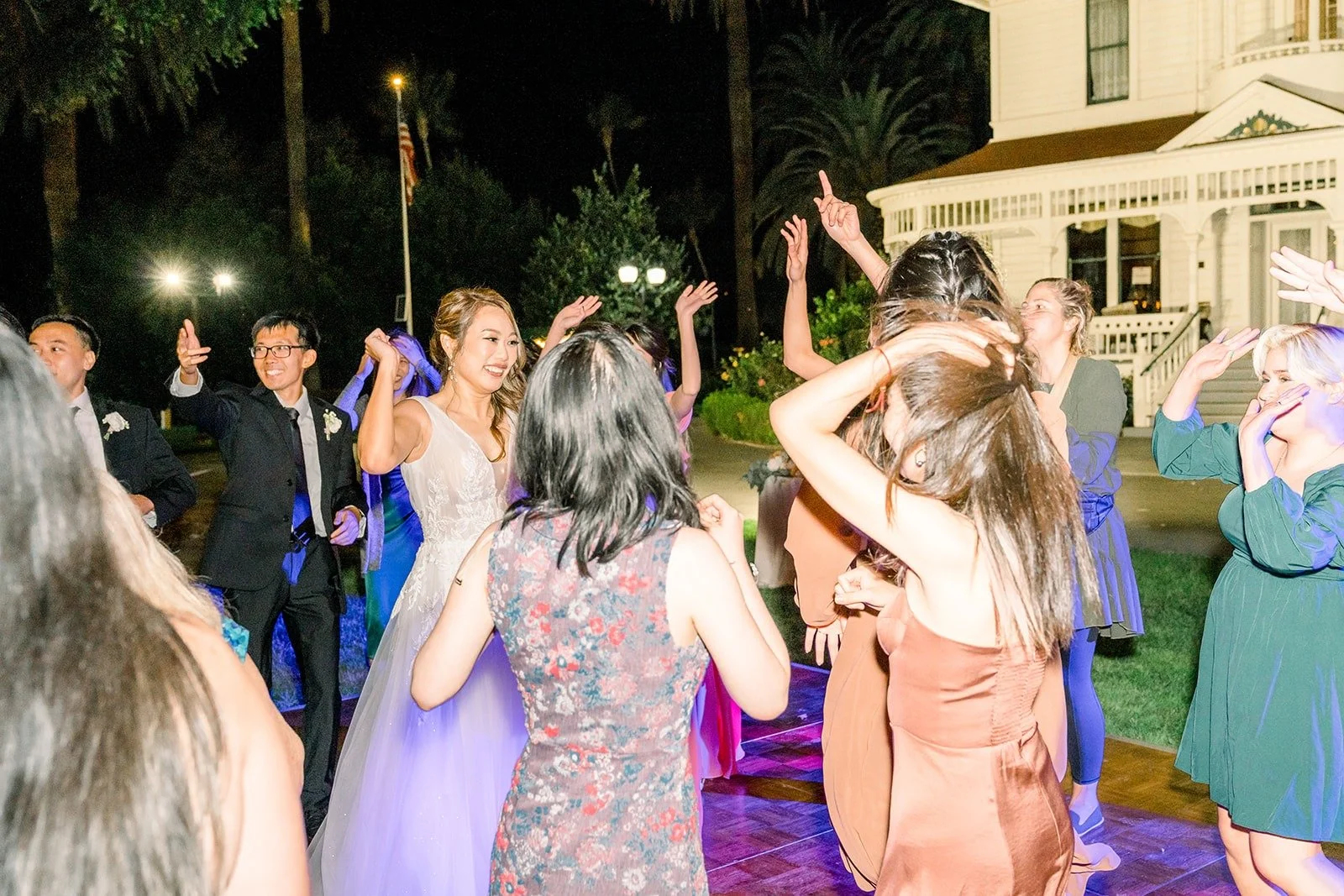 Friends dancing together on the lawn