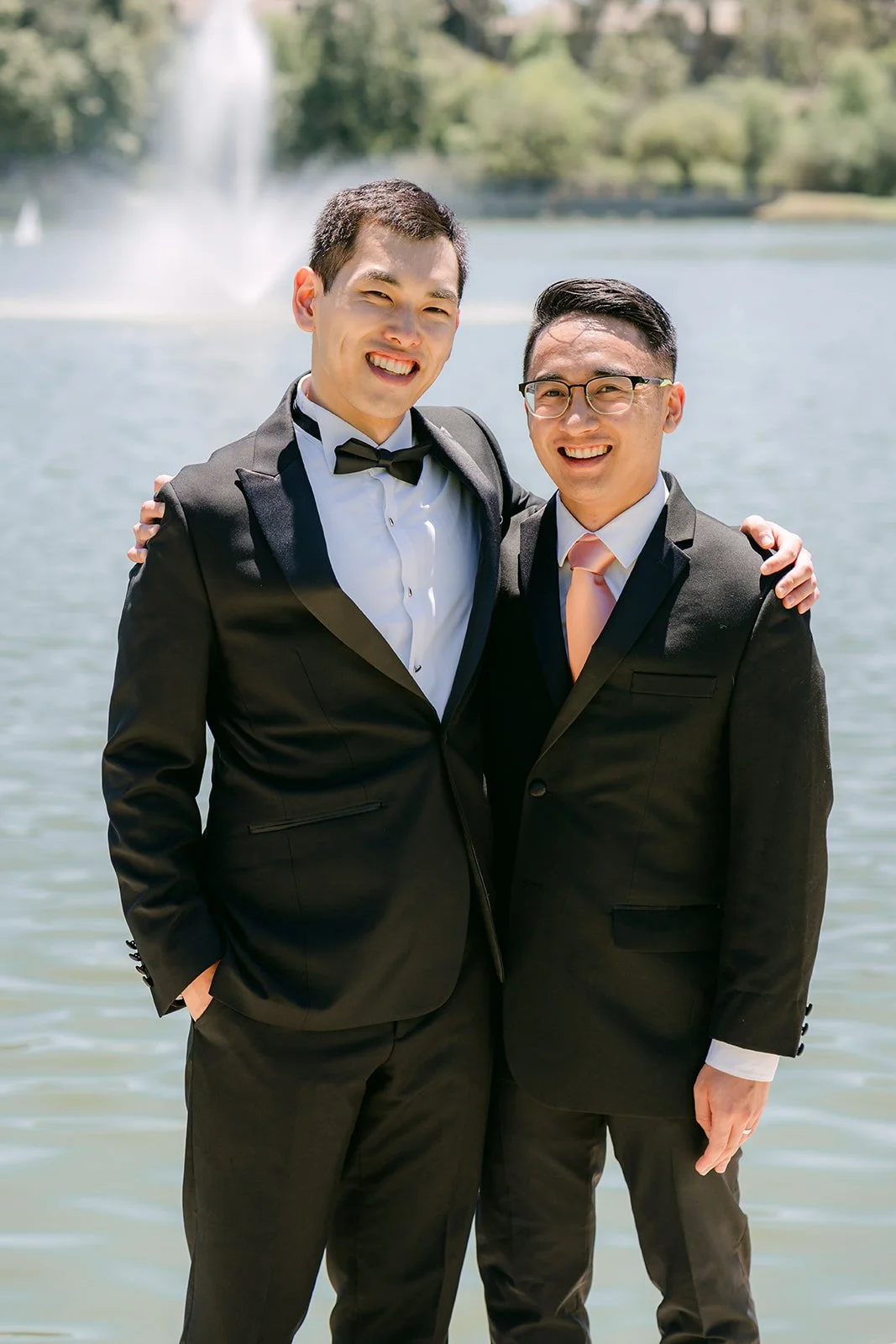 Austin with a groomsman by the fountain