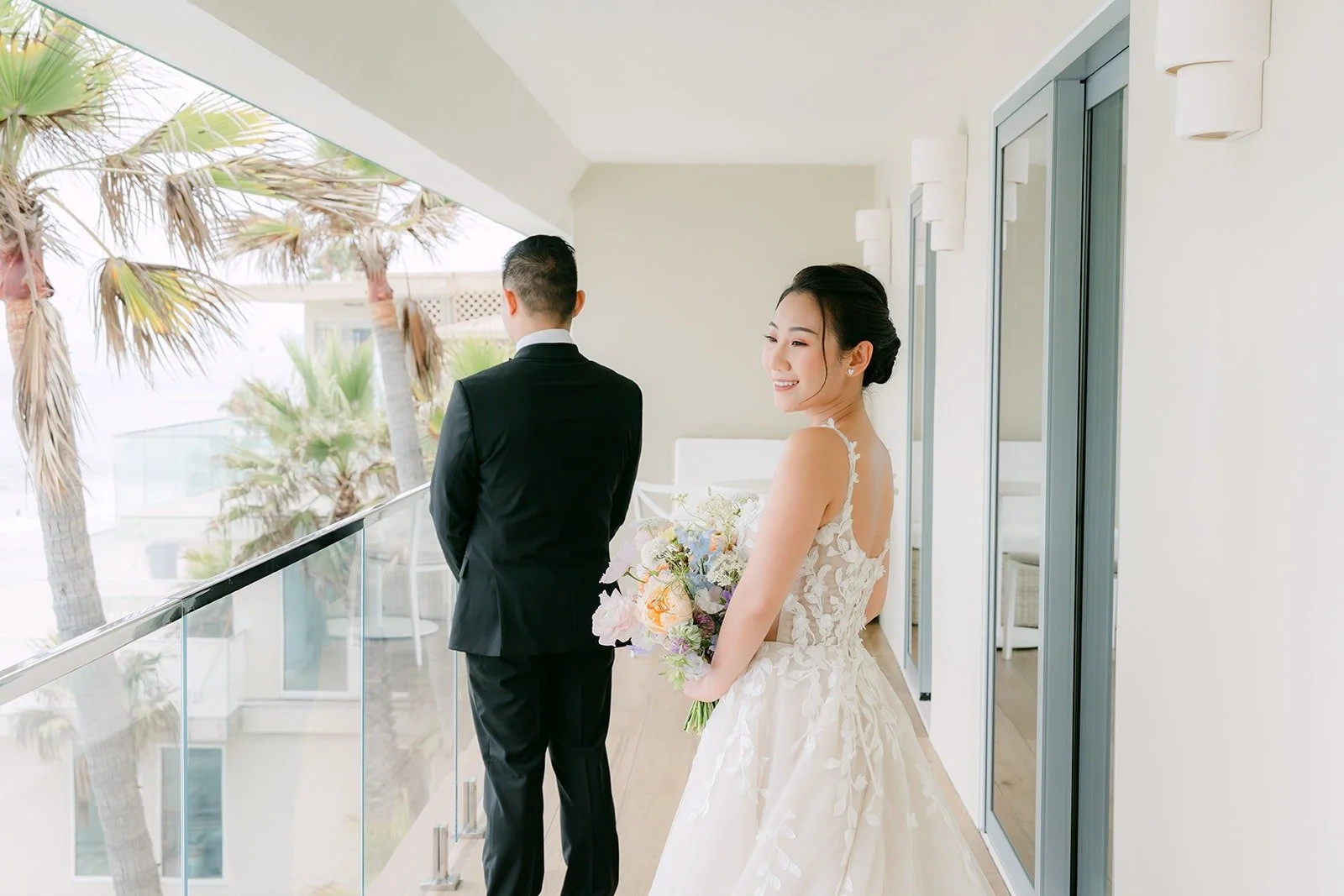 Kylie about to tap Mario on the shoulder for their first look on the balcony at Surf & Sand Resort