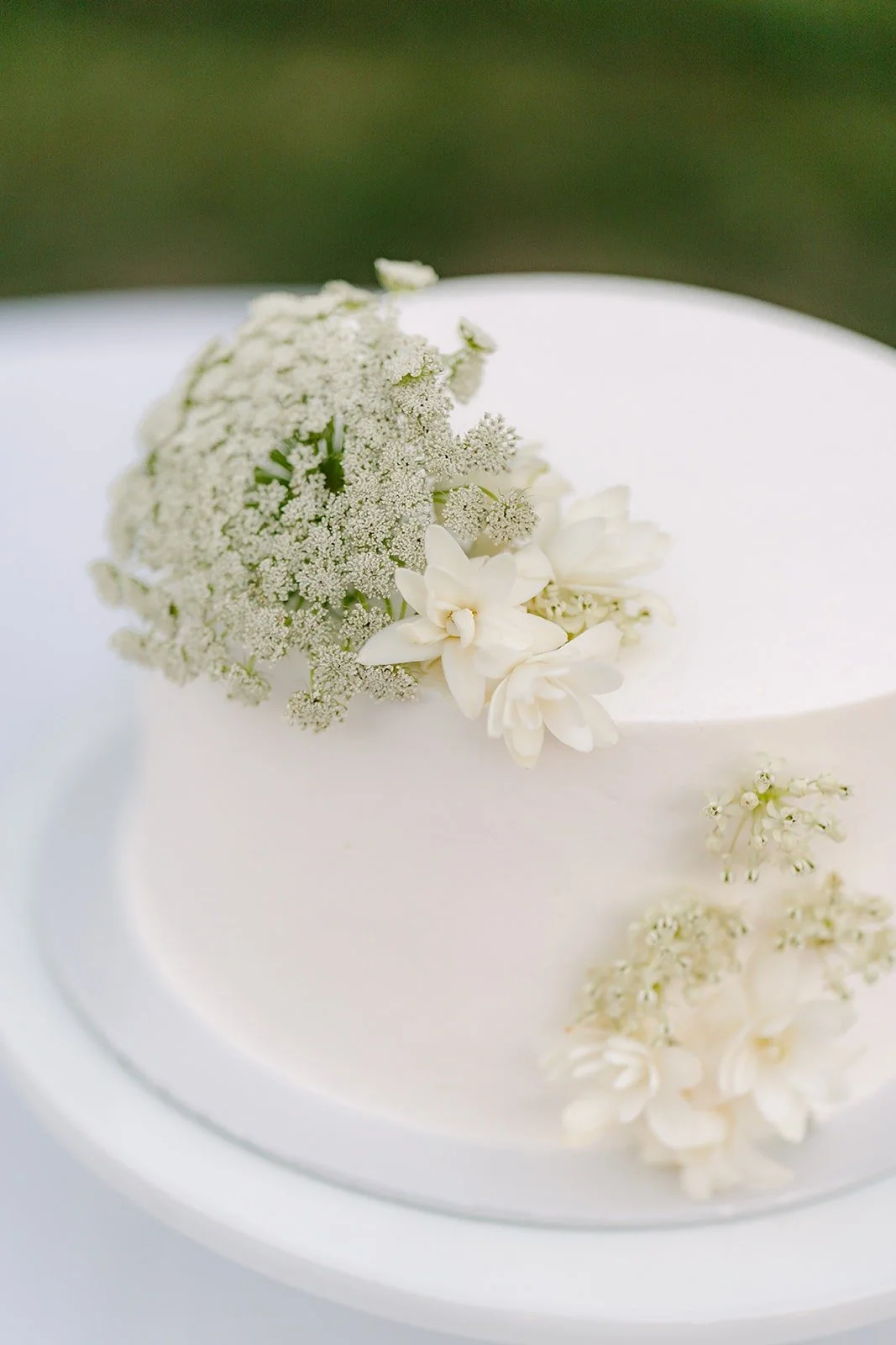 Close up of the white cake from Patty's Cake with baby's breath