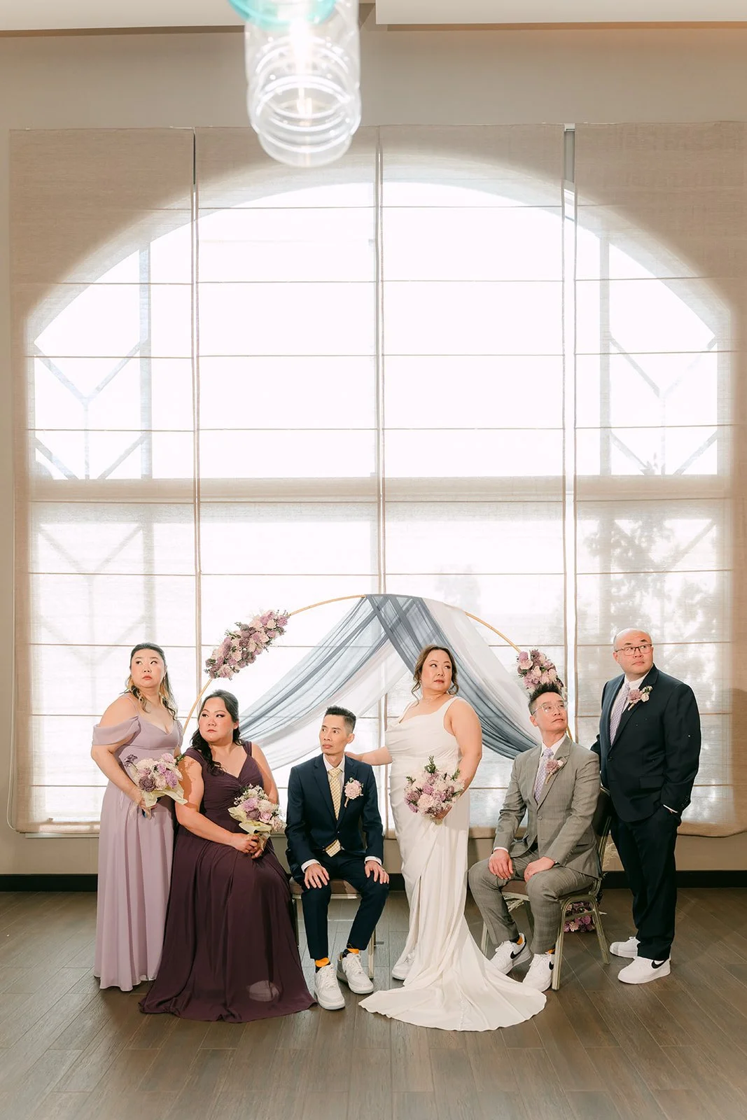 The wedding party at the ceremony arch.