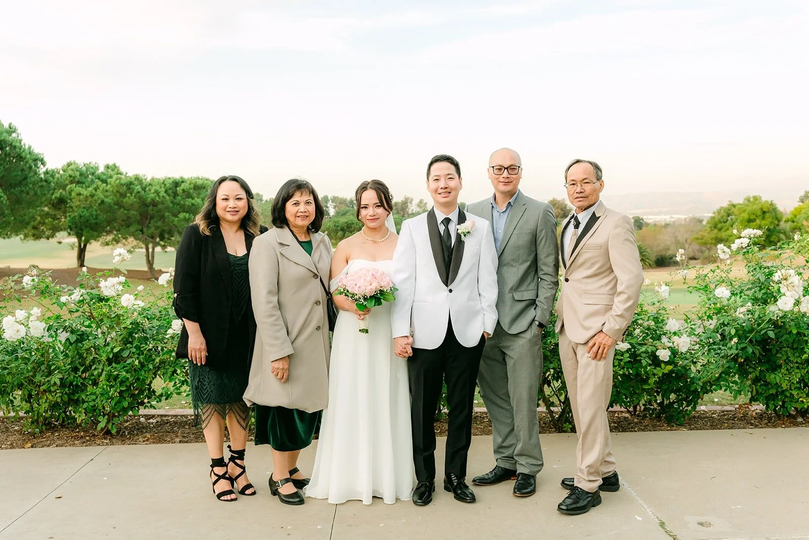 Ivy and Chungman with family on the golf course overlook