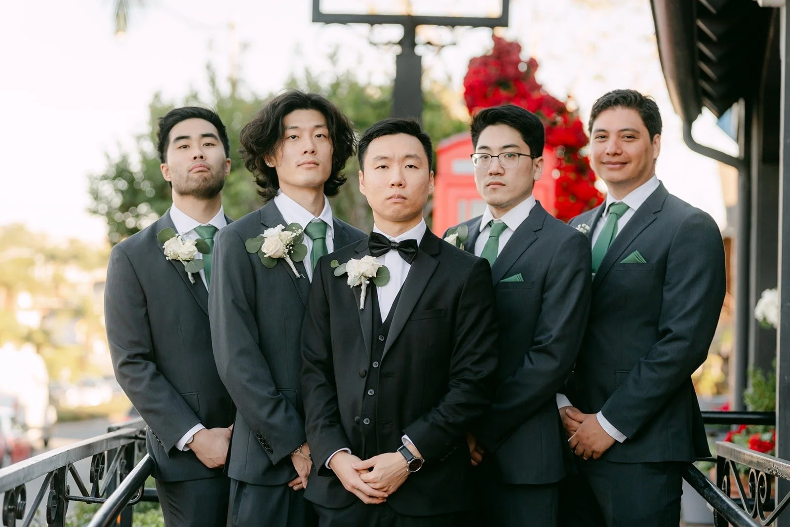 Jason and his groomsmen in grey suits and sage ties