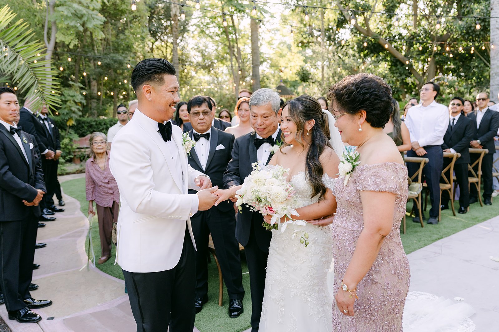 Nicole's parents joining Nicole and Caryl at the front of the aisle.